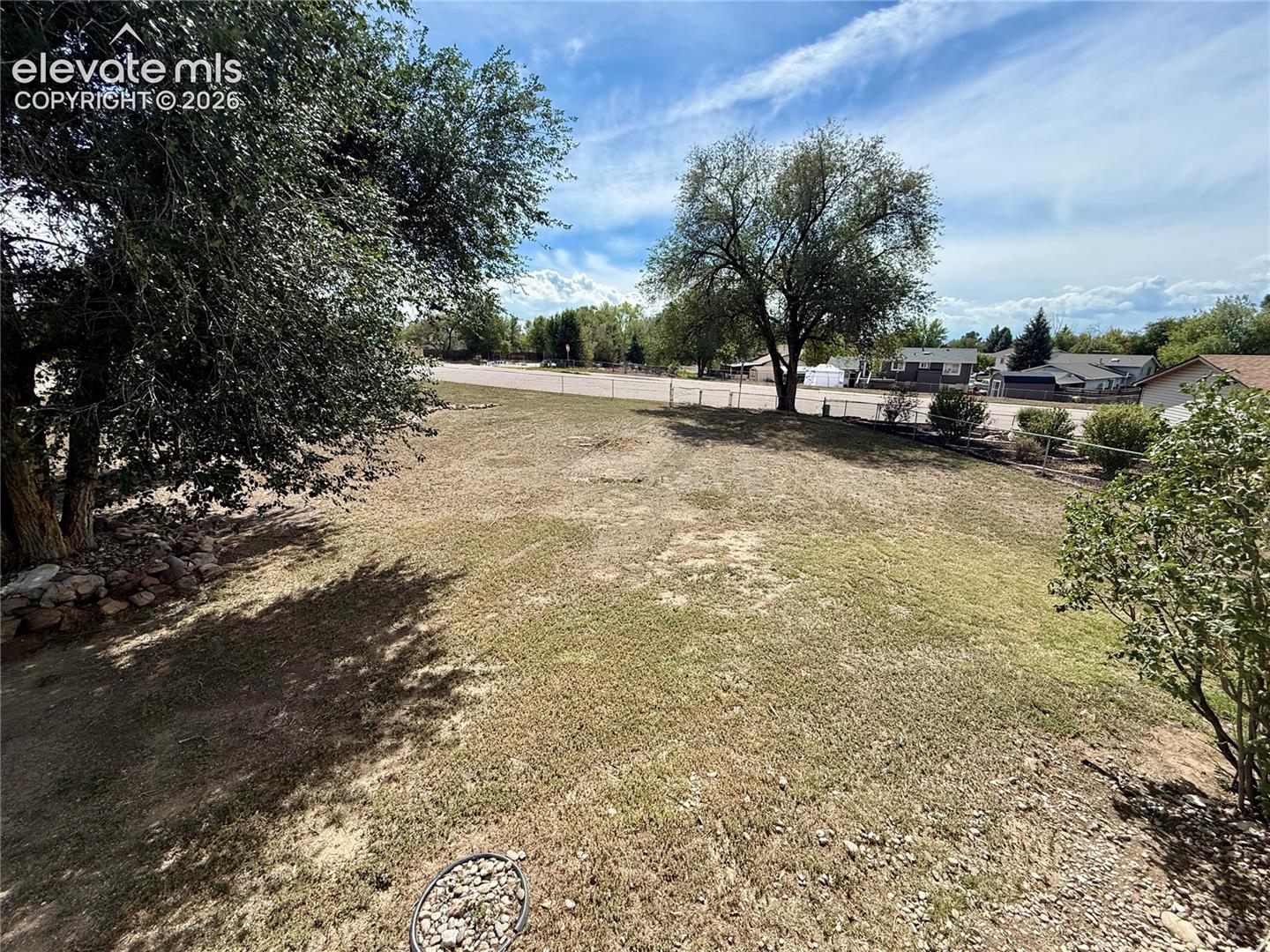 large accessible backyard with rear fence.