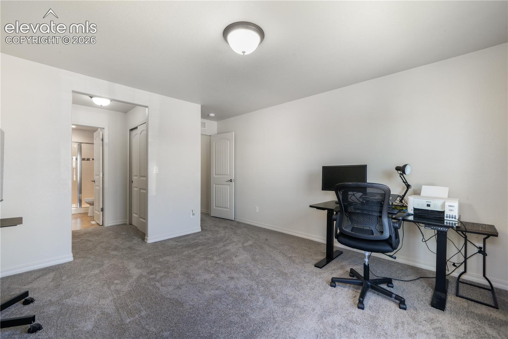 Main level 2nd bedroom with ensuite 3/4 bathroom, dual closets and new carpet