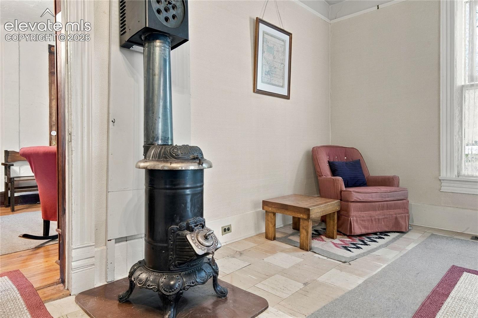 Doorway by wood burning stove leads to the large dining room