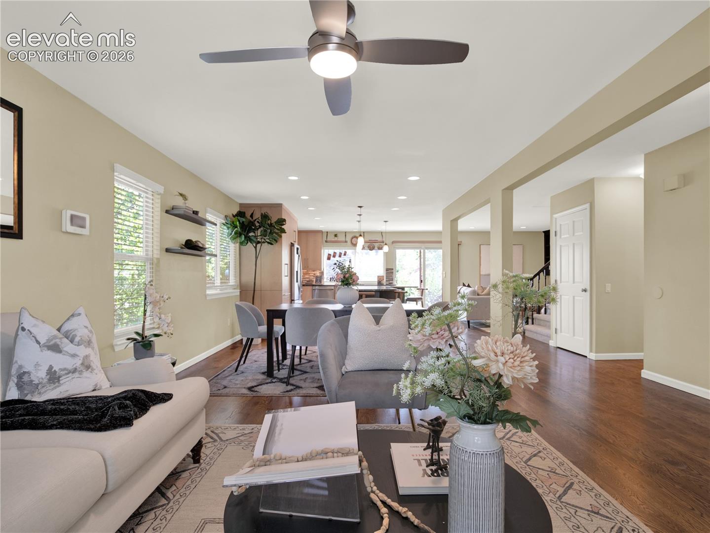 Open-concept interior featuring wood-finish flooring, recessed lighting, and a modern ceiling fan with an integrated light fixture