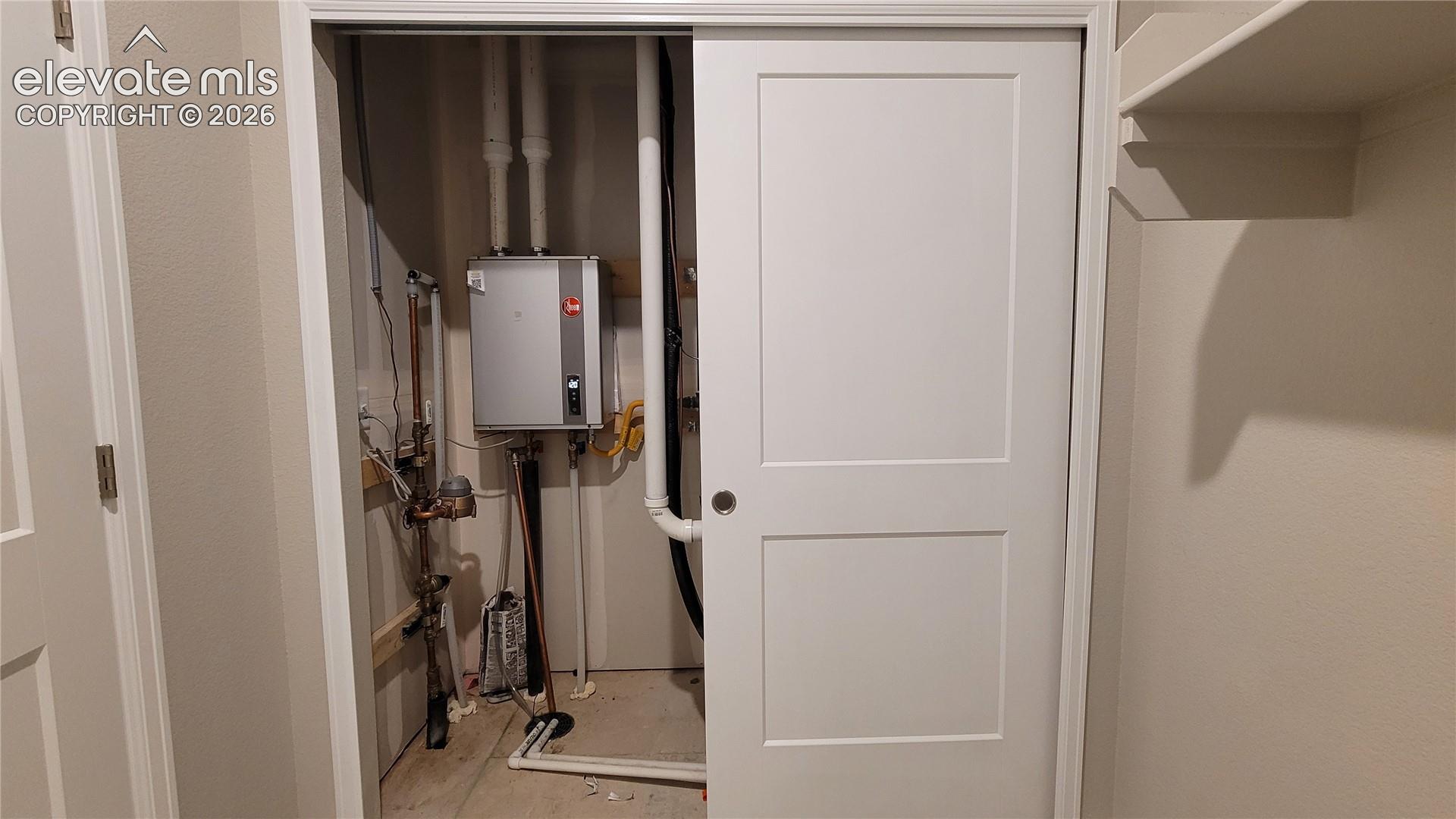 Utility closet in the laundry room with easy access to the tankless water heater! 