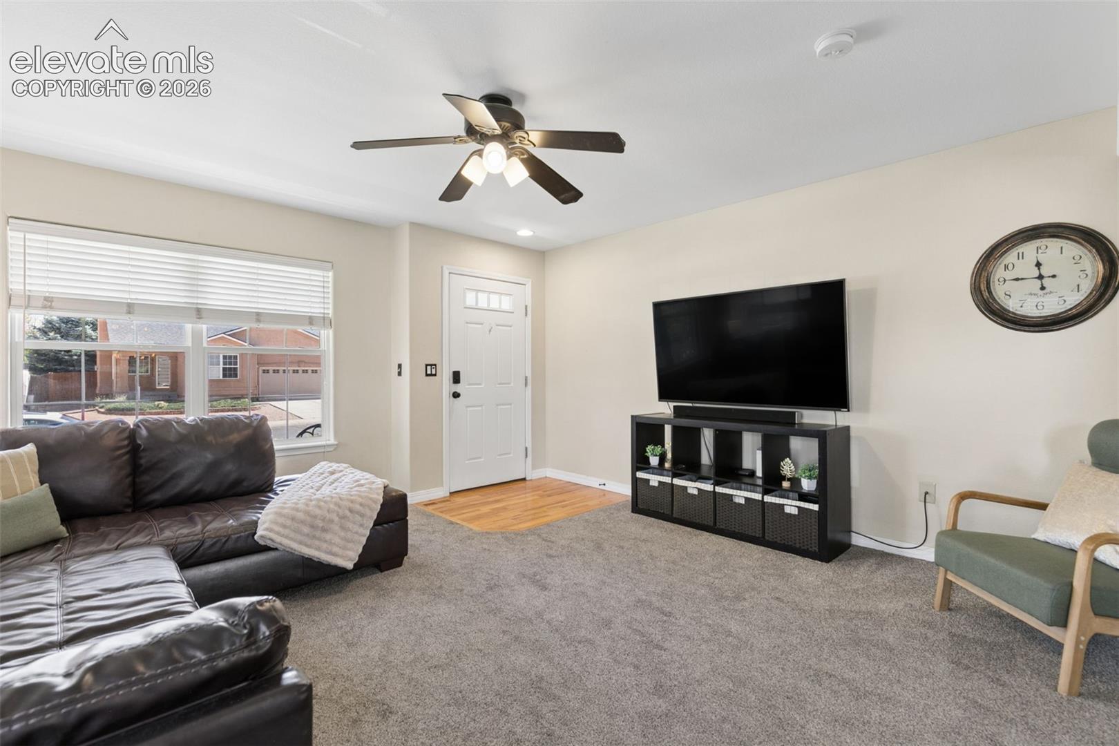 Recessed lighting, ceiling fan, and light-toned wall finishes