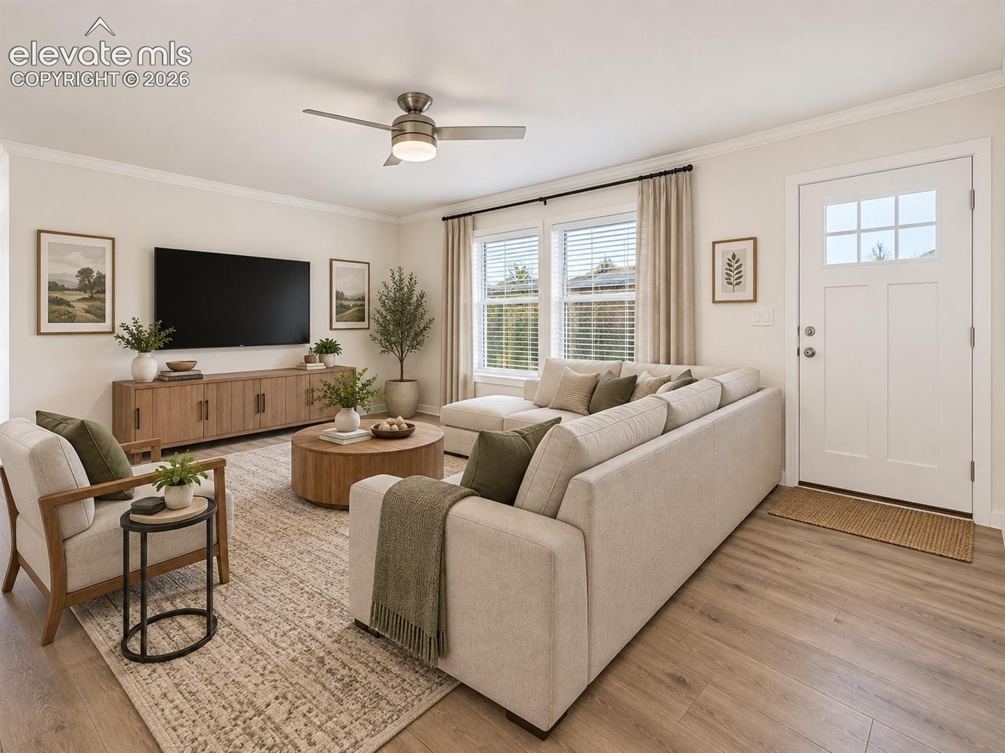 Family Room – Bright living area offers ample space for comfortable seating, with large windows, a ceiling fan, and wide-plank flooring.