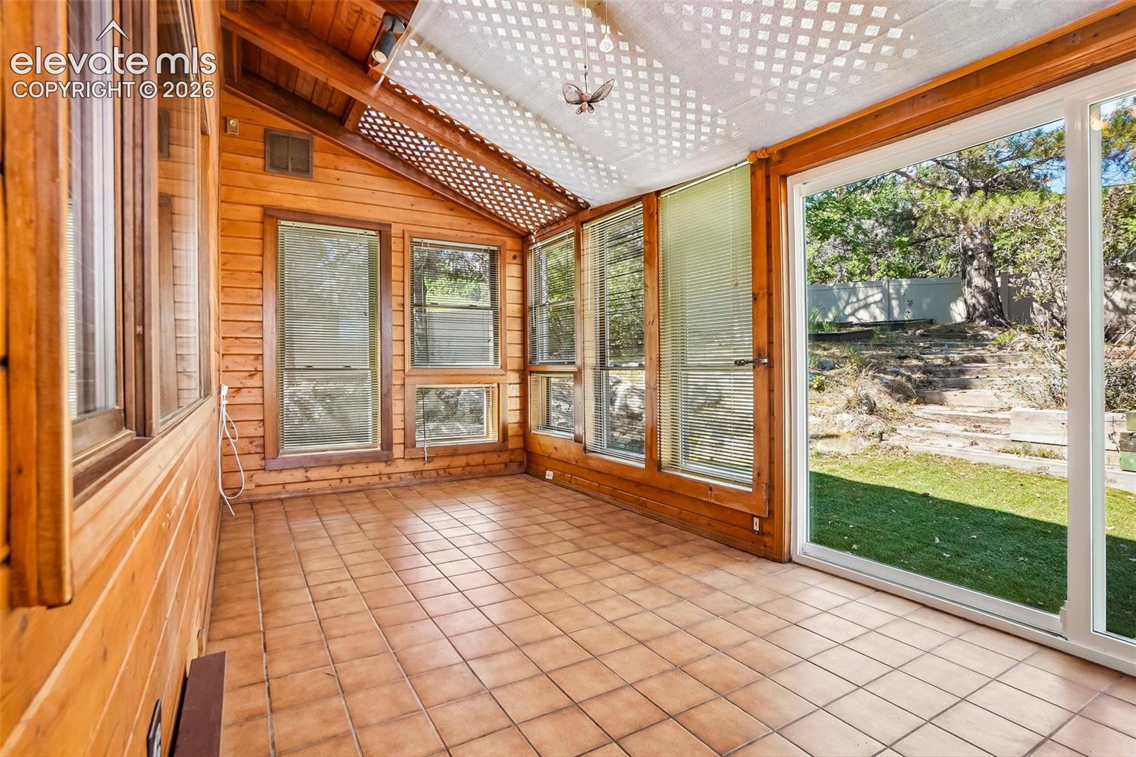 Off the large family room is a sun room with access to backyard and rear deck.