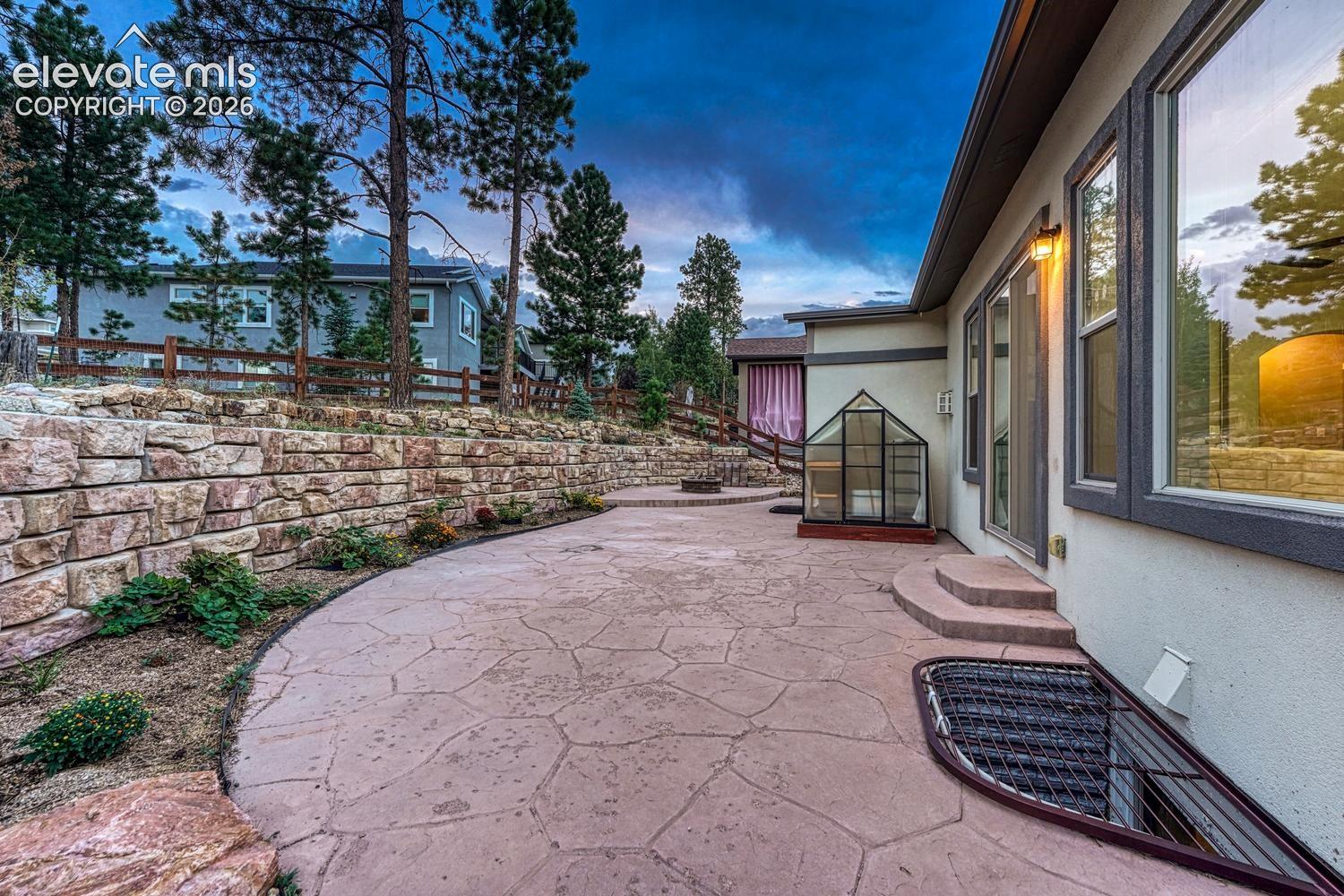 Greenhouse is included, beautiful tiered, low maintenance backyard