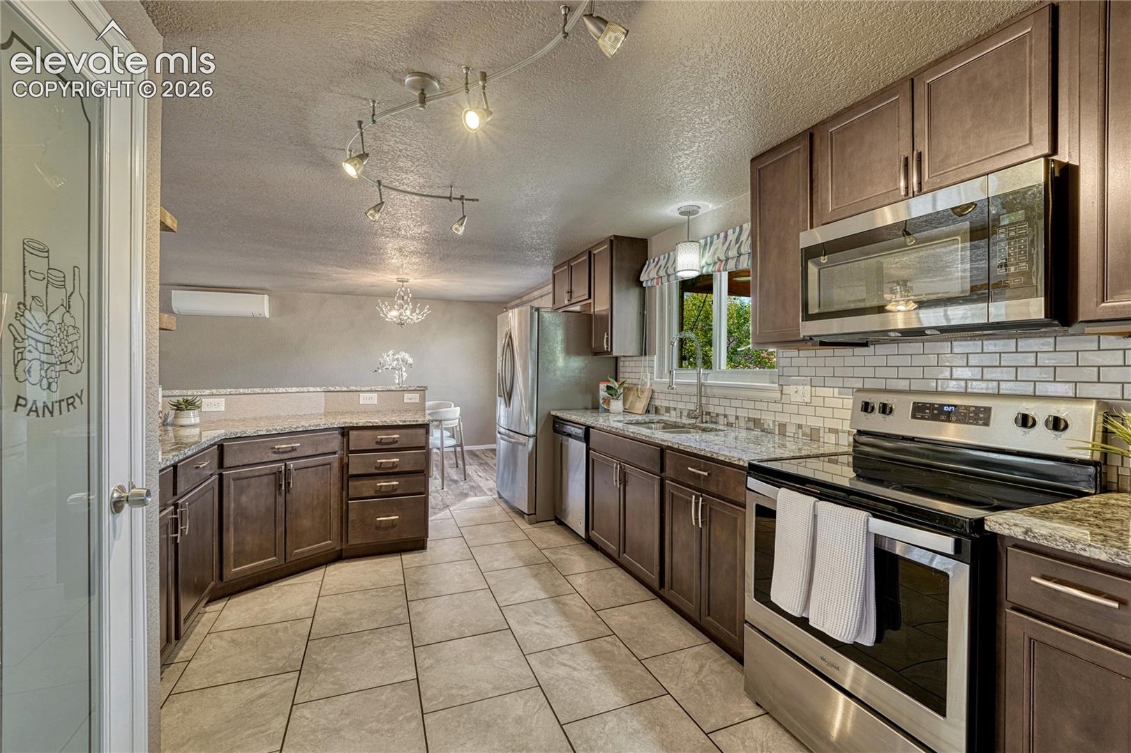 Stunning kitchen with ample cabinetry, stainless appliances and pantry!