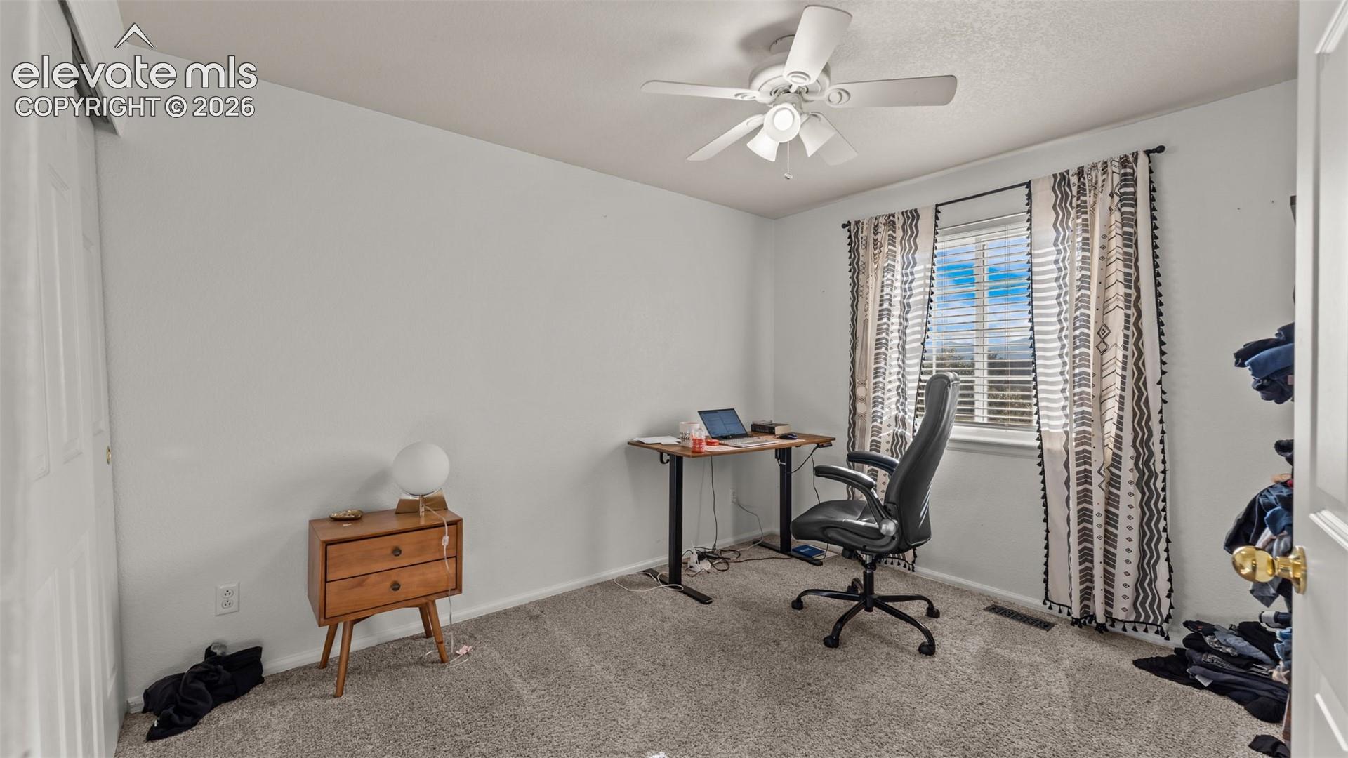 Ceiling fan with light fixture, window with blinds, and wall-to-wall carpeting