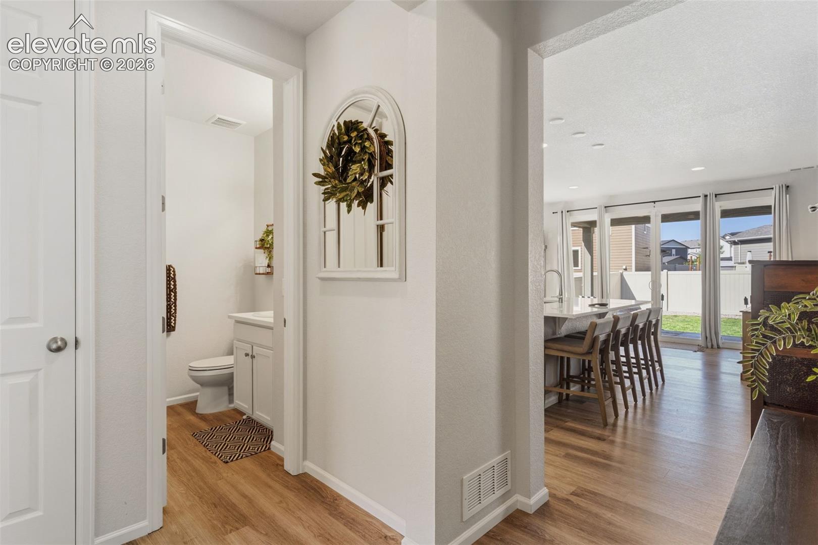 Bright interior featuring wood-finish flooring and white painted walls