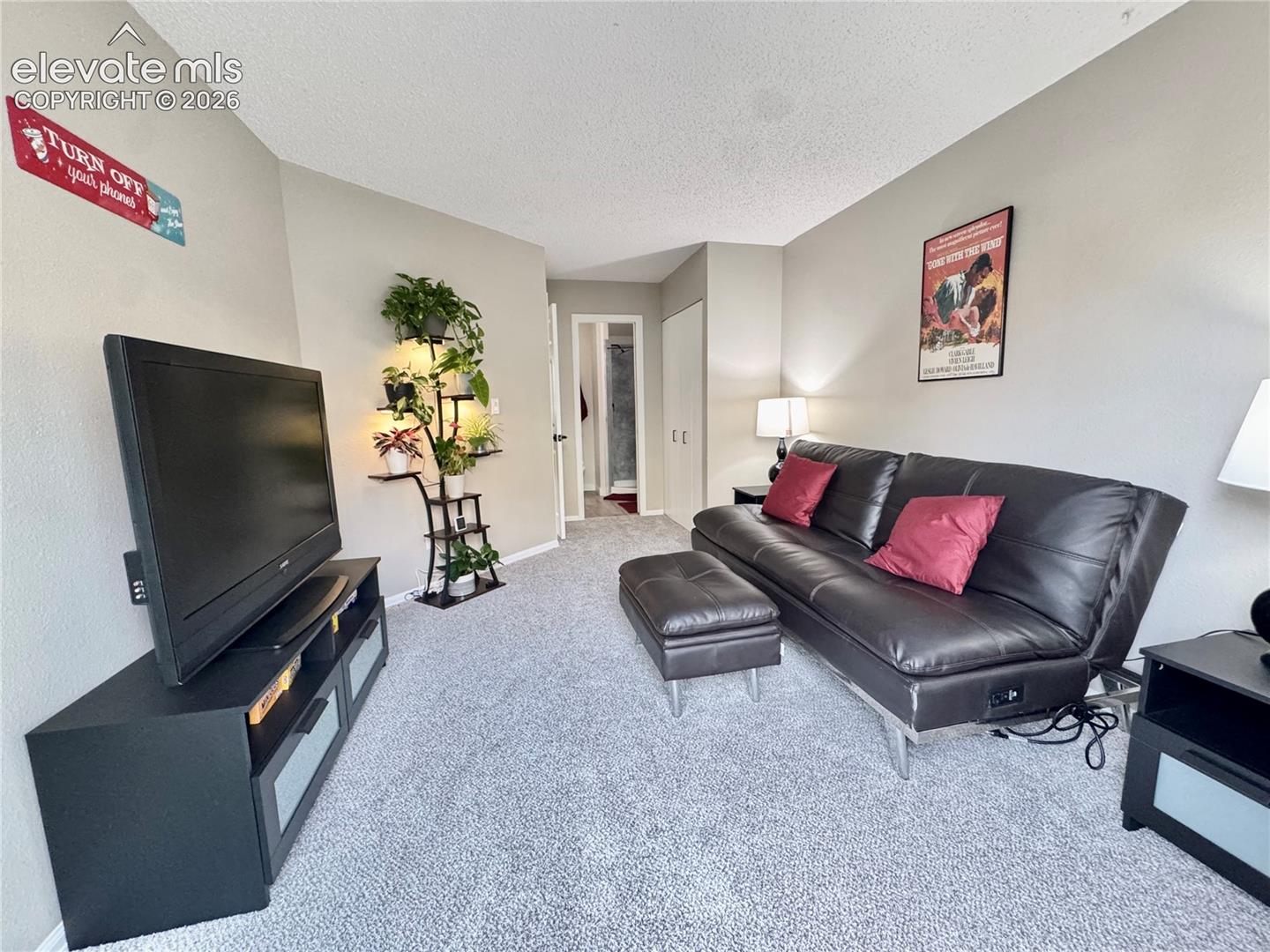 Neutral interior space featuring wall-to-wall carpeting and closet storage