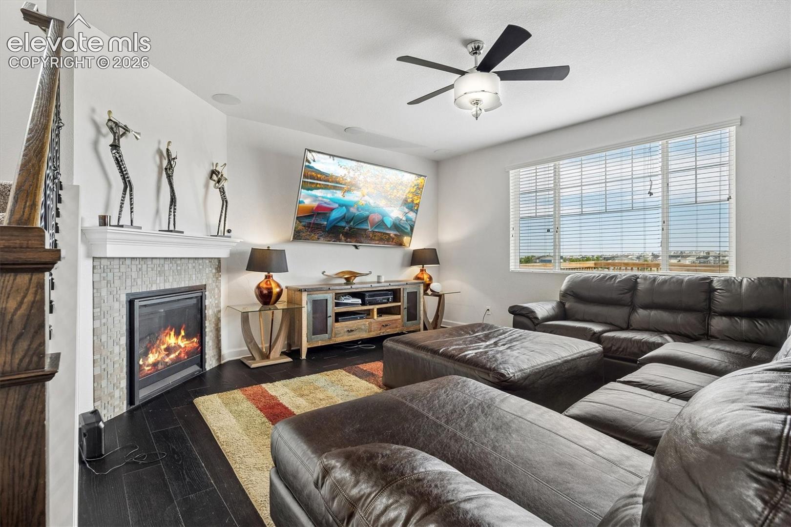 Living area featuring a fireplace with a tiled surround and mantel