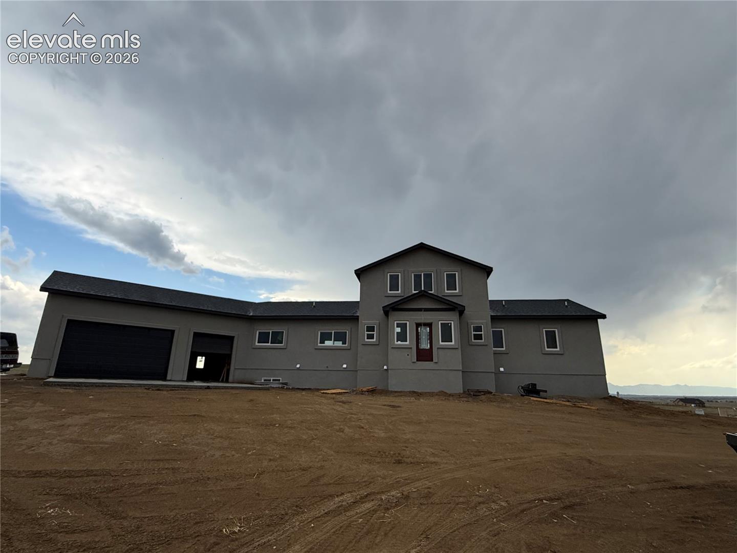 This gorgeous new construction home  at the Reserve At Corral Bluffs offers the perfect balance of wide-open country living withoutfeeling remote. Set on 5 acres with breathtaking 360-degree views including window framed views of Pikes Peak.With land surrounding the home, privacy is abundant. This thoughtfully designed 1.5-story home features nearly 3,900square feet of finished living space with an open-concept great room showcasing vaulted ceilings, a gas fireplace, andexpansive windows that frame the incredible scenery. The gourmet kitchen includes granite countertops, a large island,walk-in pantry, and flows seamlessly into the dining area. Step outside to the deck or walk-out patio and enjoy unforgettable sunrises and sunsets from multiple outdoor living spaces. The main-level primary suite offers a private retreat with walk-out access, a spacious walk-in closet, and a luxurious five-piece bath featuring a double vanity, soaking tub, and separate shower. The finished walk-out basement expands the living space witha massive family room, wet bar, four additional bedrooms, and two full bathrooms. A loft adds even more usable space for ahome office or secondary living. Additional highlights include a three-car oversized attached garage with 9 ft garage doors, RV parking, Two Laundry rooms - one on the main level and one on the basement level. Easy access to Woodmen, Falcon, and the Powers corridor. Conveniently located near Schriever and Peterson AFB.  Call with questions today.