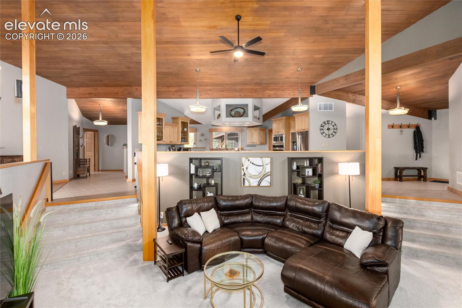 Vaulted wood-finish ceilings with exposed beams and ceiling fans