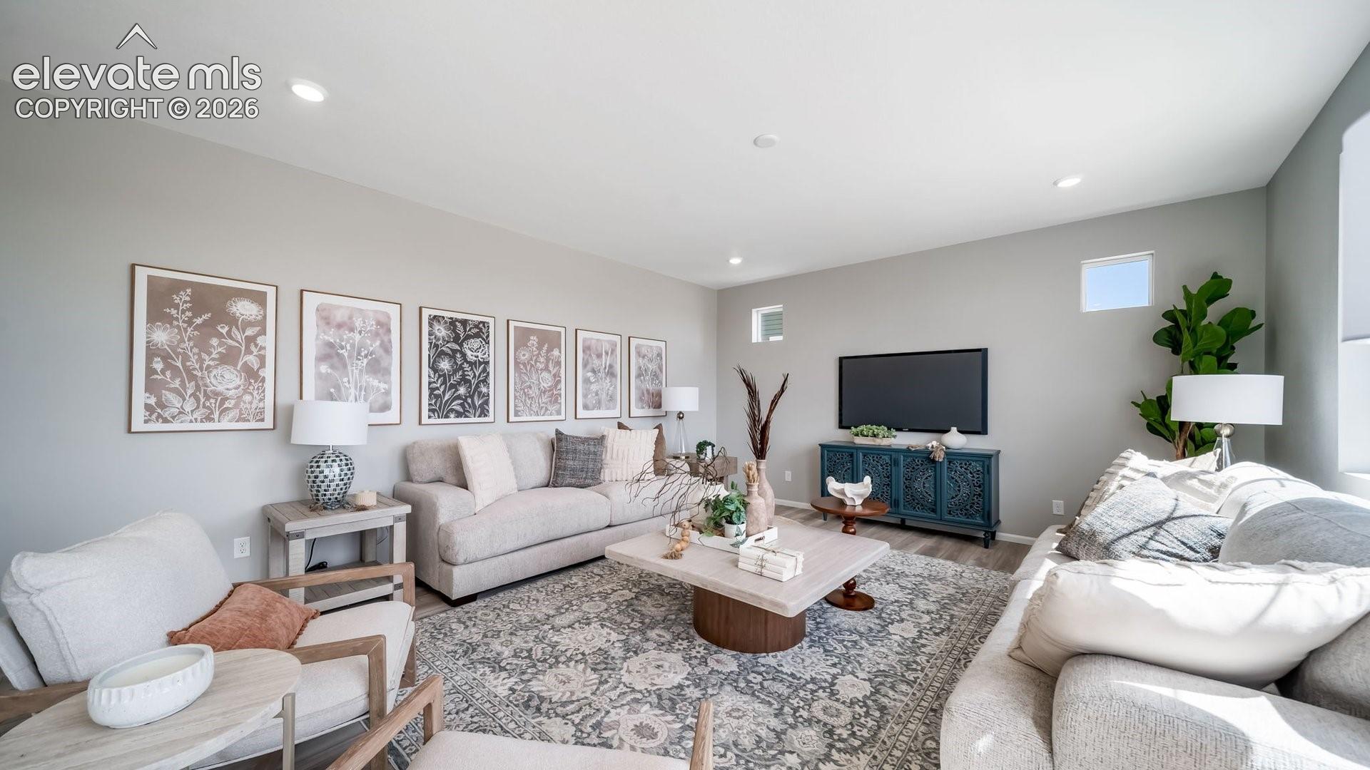 Recessed ceiling lighting, light gray wall paint, wood-finish flooring, and multiple windows
*photos of a model home*