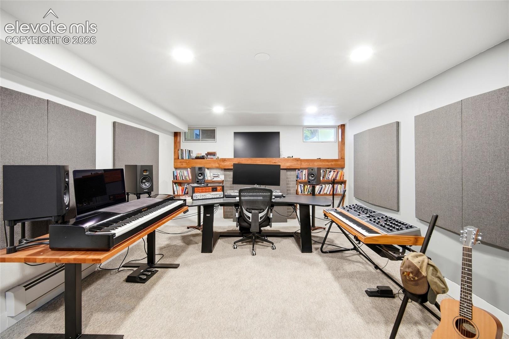 The downstairs family room has a wood-burning fireplace and is currently in use as an office and sound studio. 