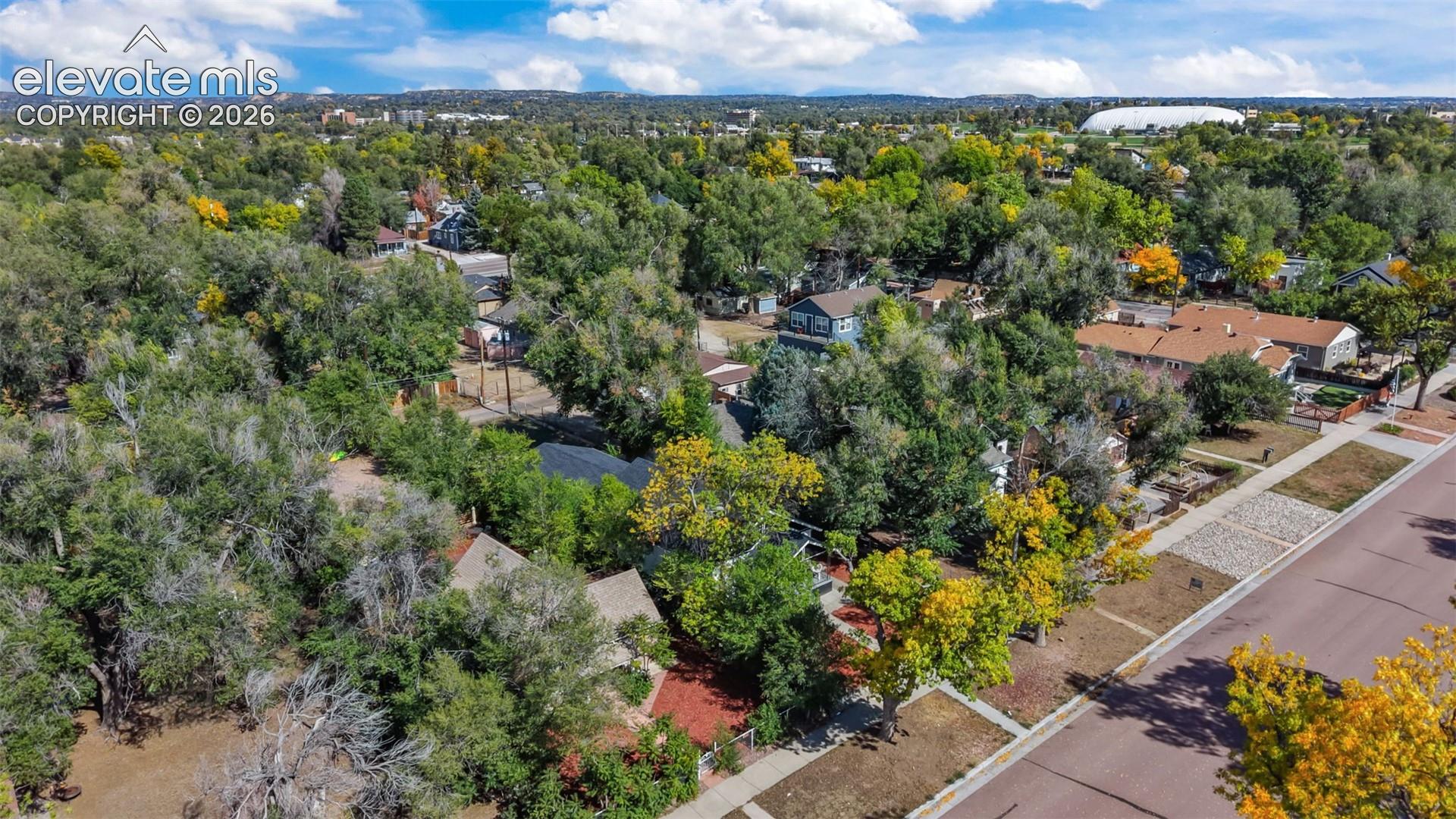 Lush tree-lined property featuring mature landscaping and verdant grounds