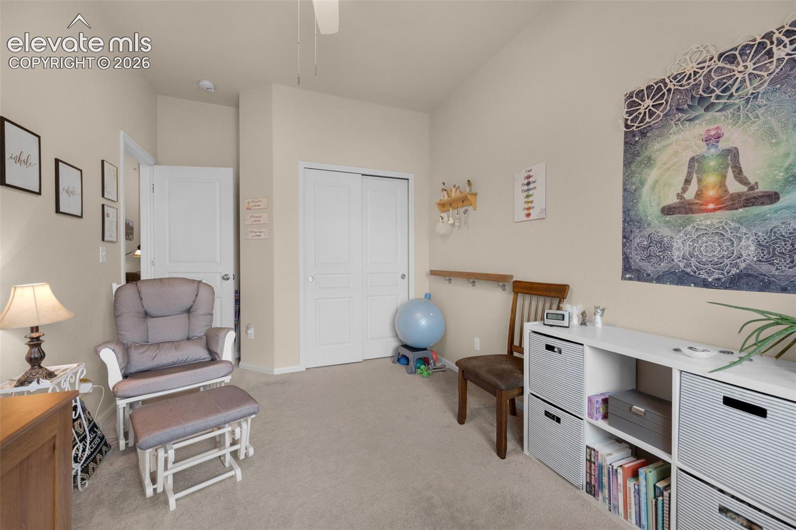 Bedroom #2 being used as an office. Neutral-toned room featuring a vaulted ceiling and light-colored carpeting