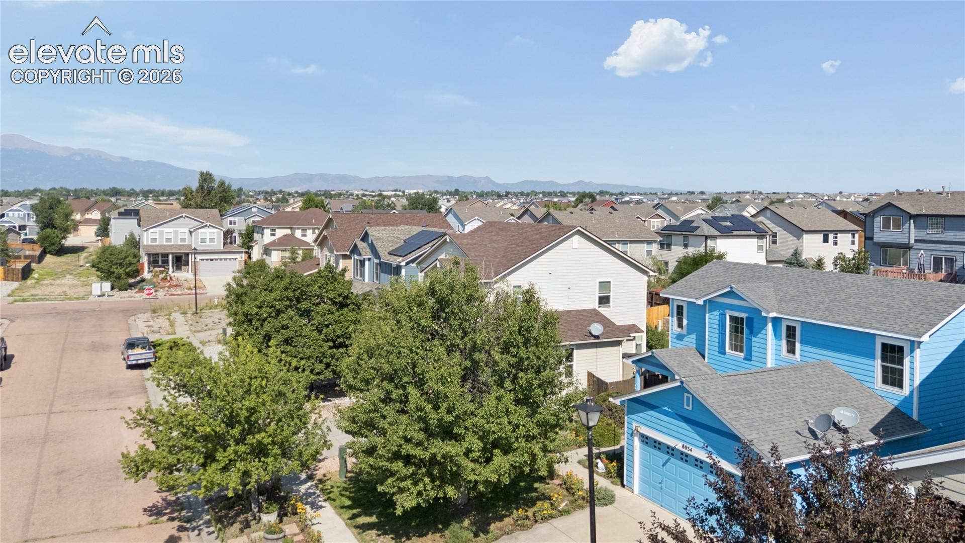 Neighborhood overview featuring varied architectural styles and mature trees