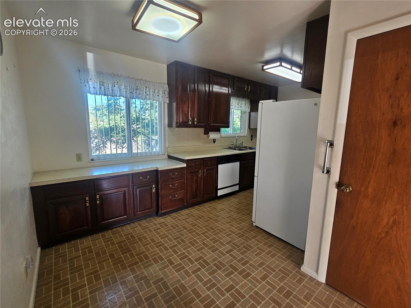 Kitchen wood cabinetry, light-toned countertops