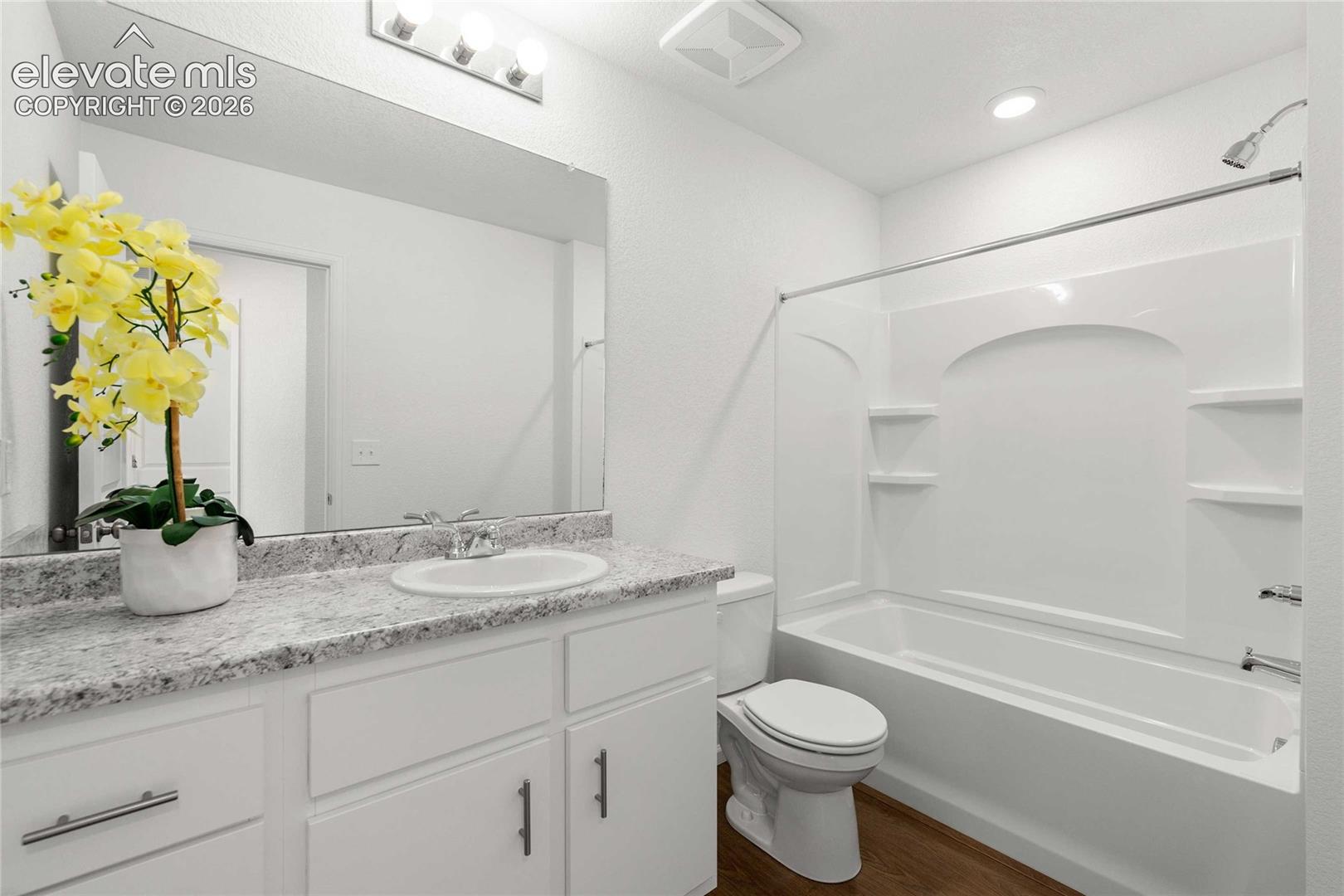 White vanity with a light-toned countertop and an integrated sink
*photos  of a model home*