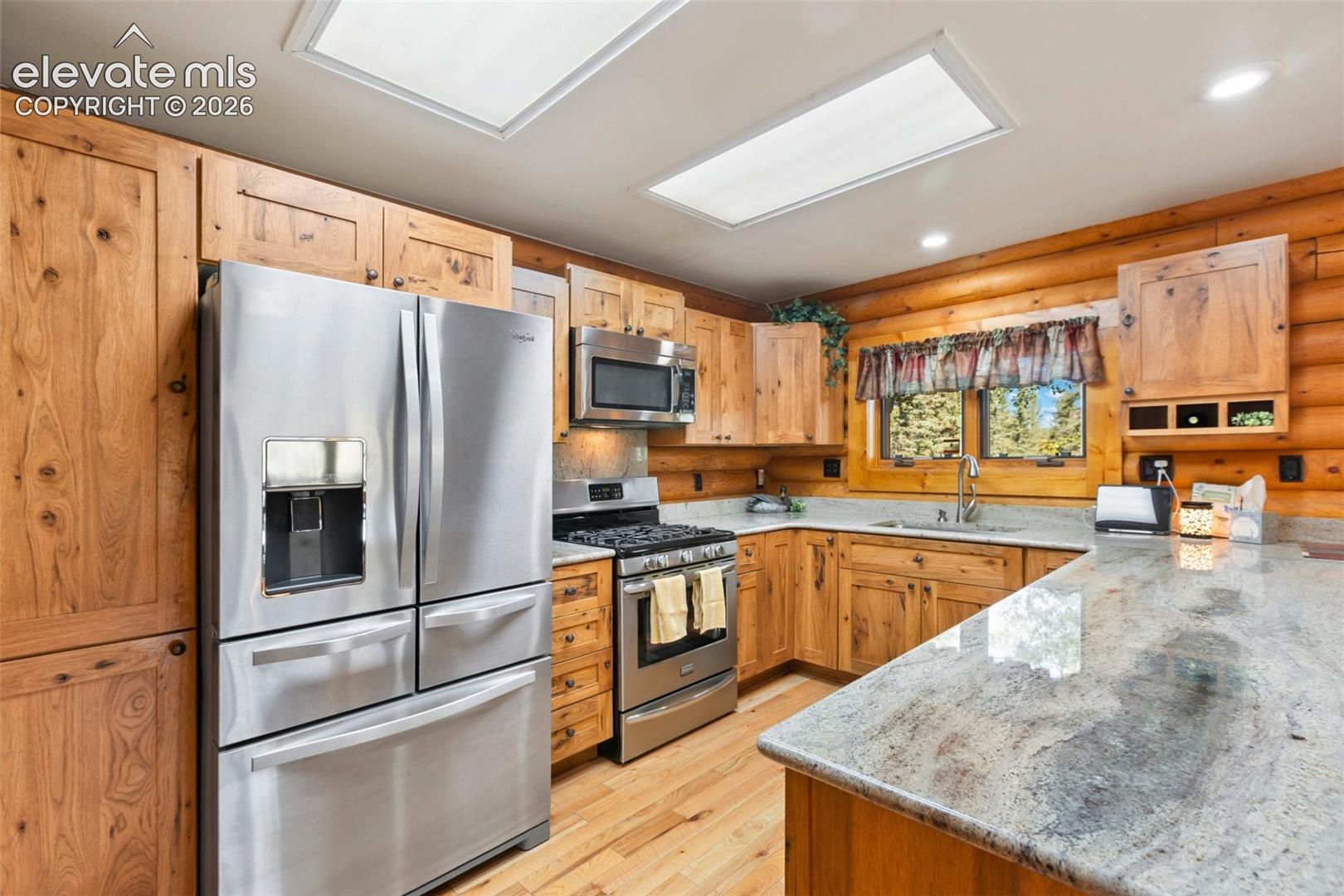 Kitchen with white oak cabinets and granite counter top. All stainless steal appliances. 