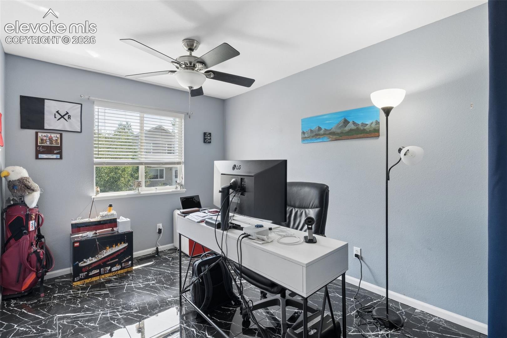 Room featuring black marble-finish flooring, a ceiling fan with integrated lighting, and a window with horizontal blinds