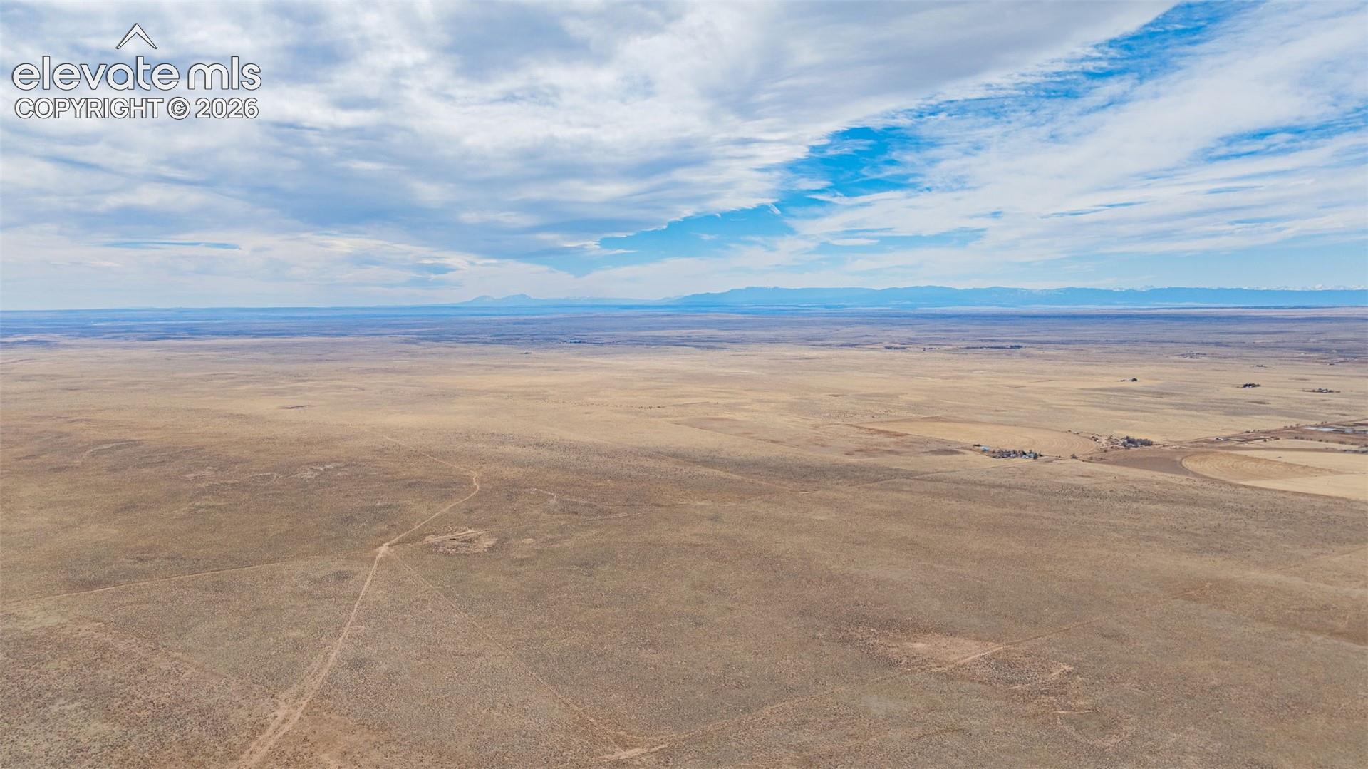 Expansive acreage featuring natural topography and distant mountain horizons