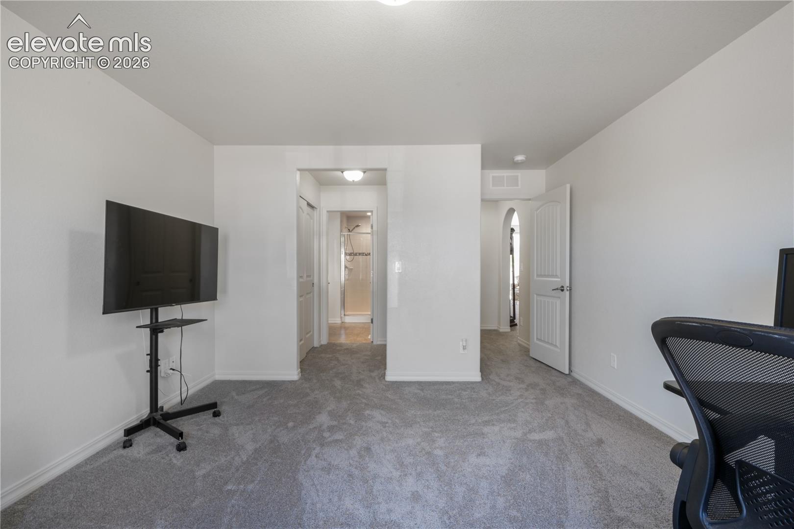 Main level 2nd bedroom with ensuite 3/4 bathroom, dual closets and new carpet