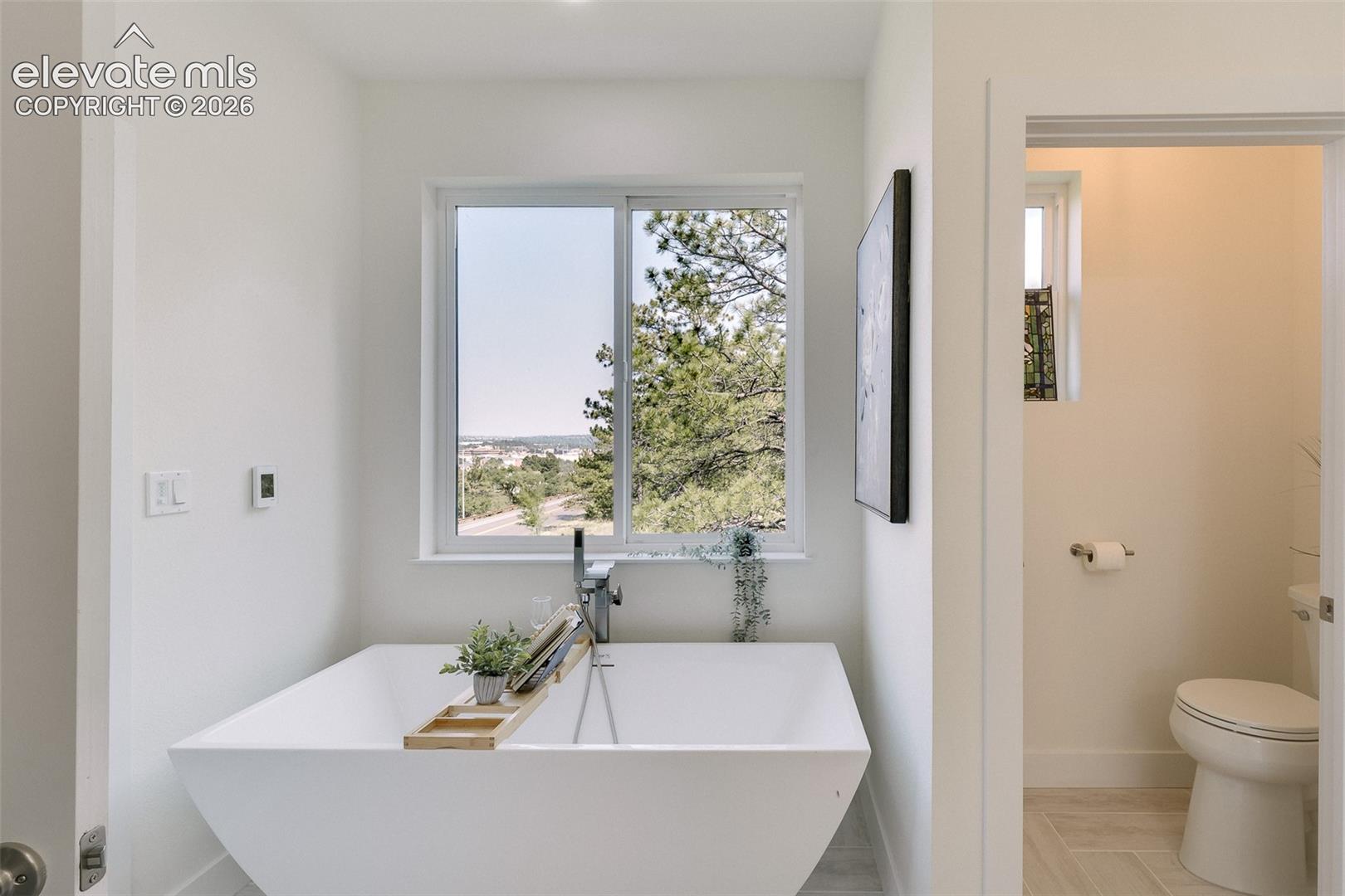 Relax and enjoy beautiful views from the large soaking tub in the Primary Bathroom.