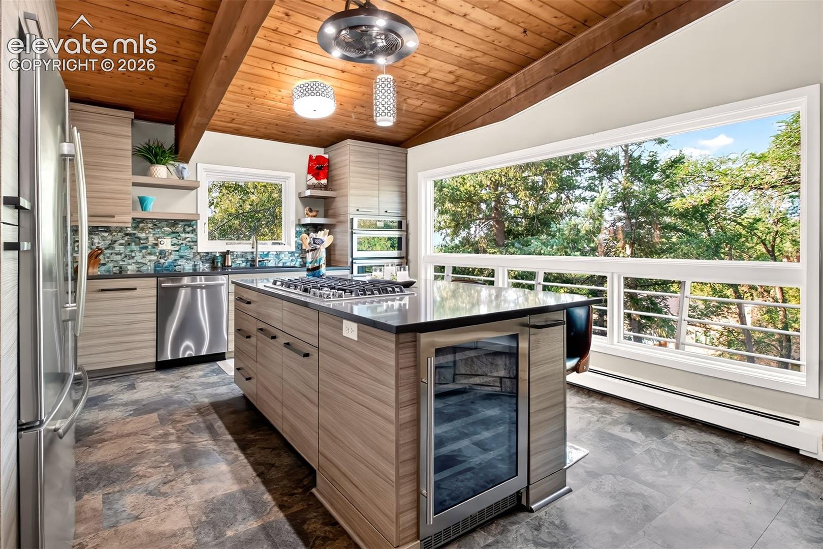 The kitchen is amazing! Custom cabinetry, Quartz countertops, and glass tile backsplash are complimented by upaded stainless steel appliances. And what a view from the ribbon window!