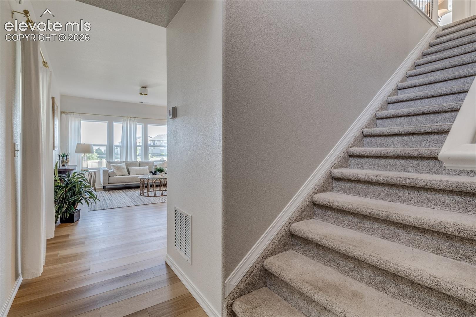 From the front door you can go up the stairs or go down the hallway into the living area