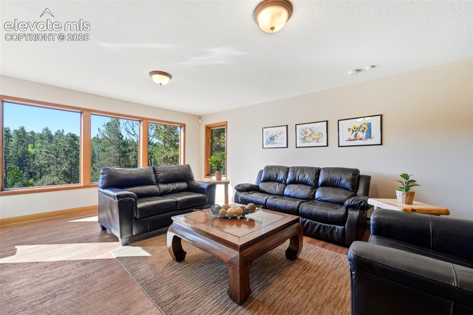 Expansive windows, wood-finish flooring, and recessed lighting
