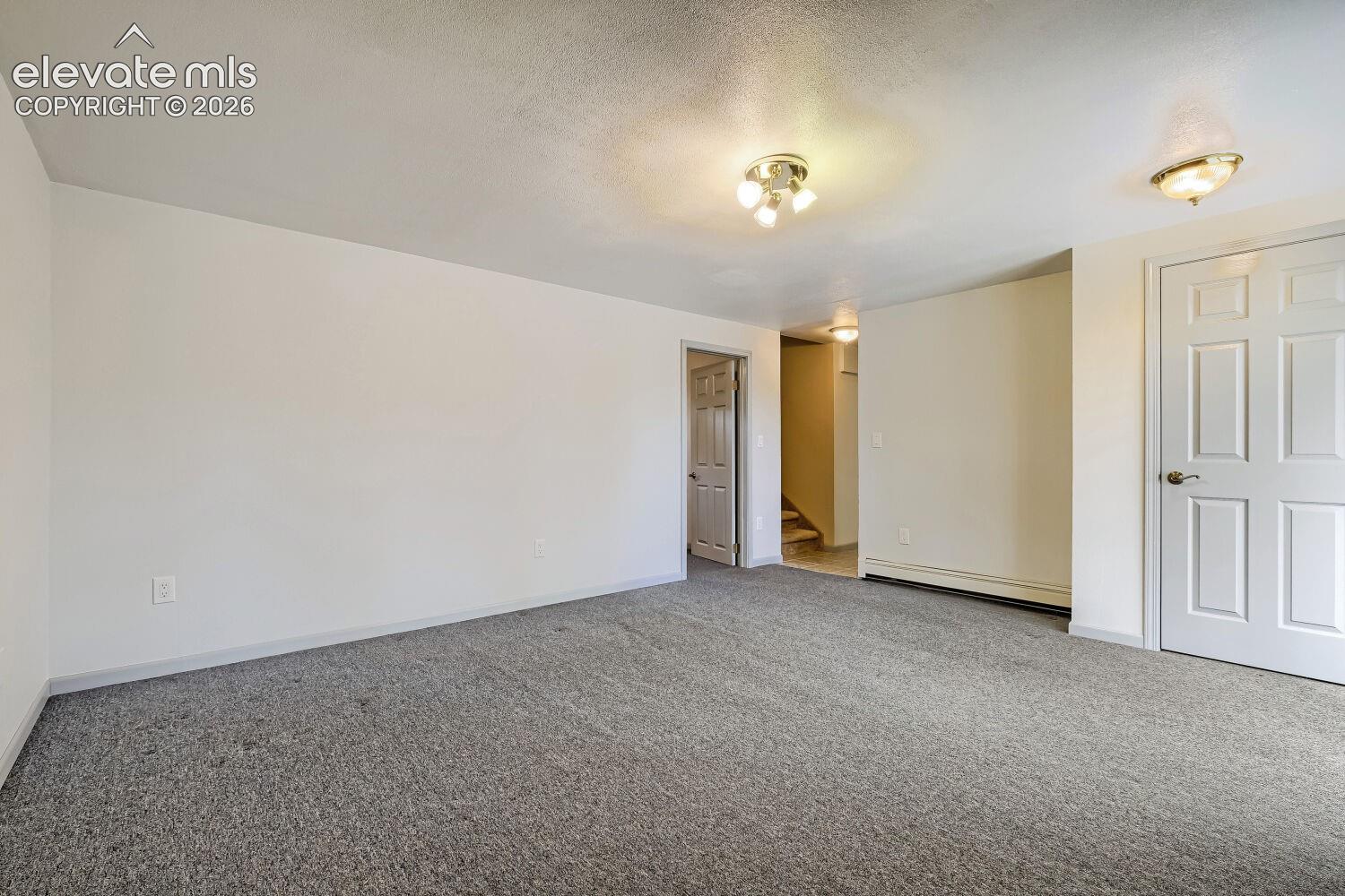Neutral wall finishes, recessed lighting, and carpeted flooring