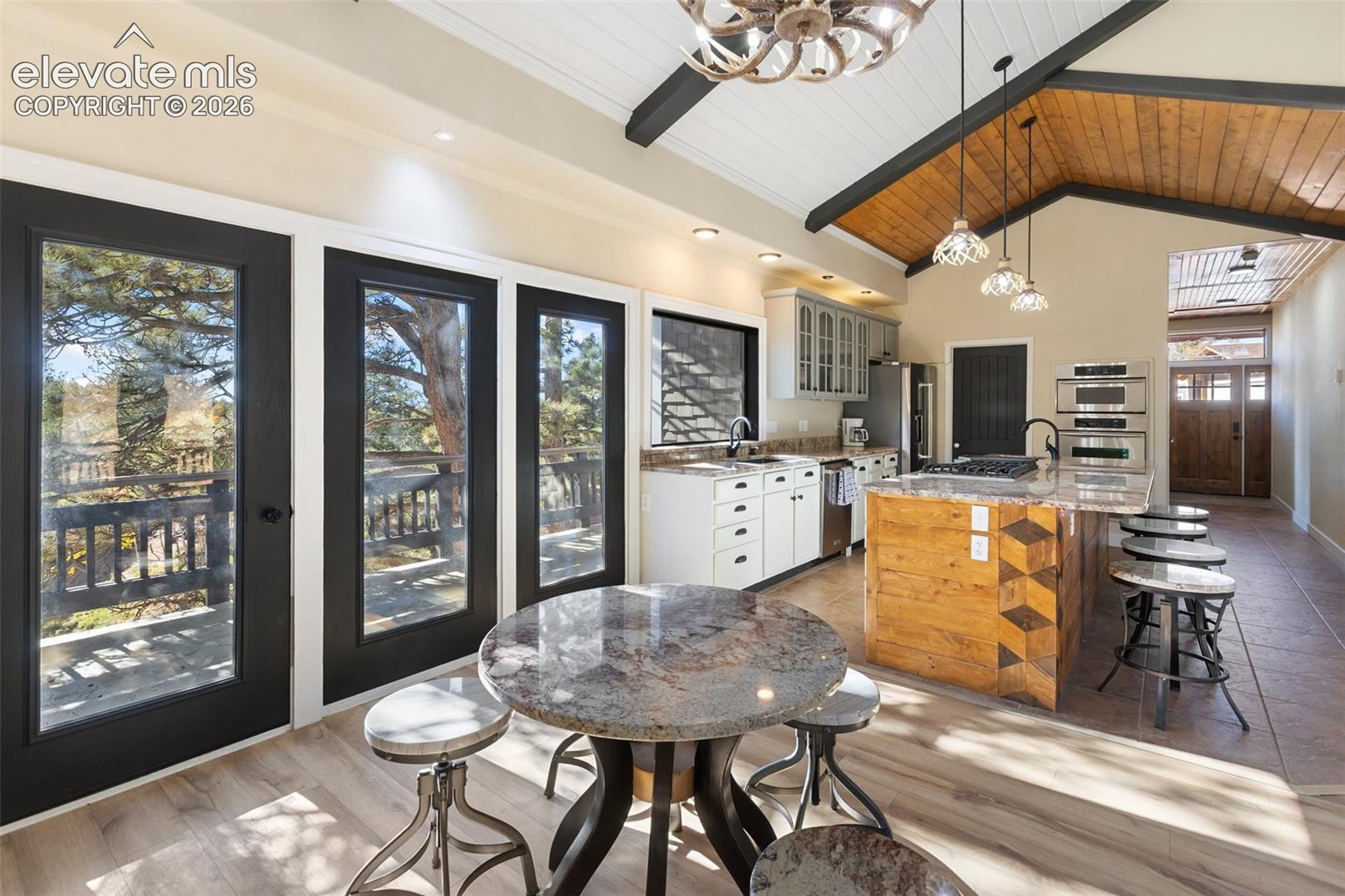 Dining and Kitchen view of entry and walkout . 
