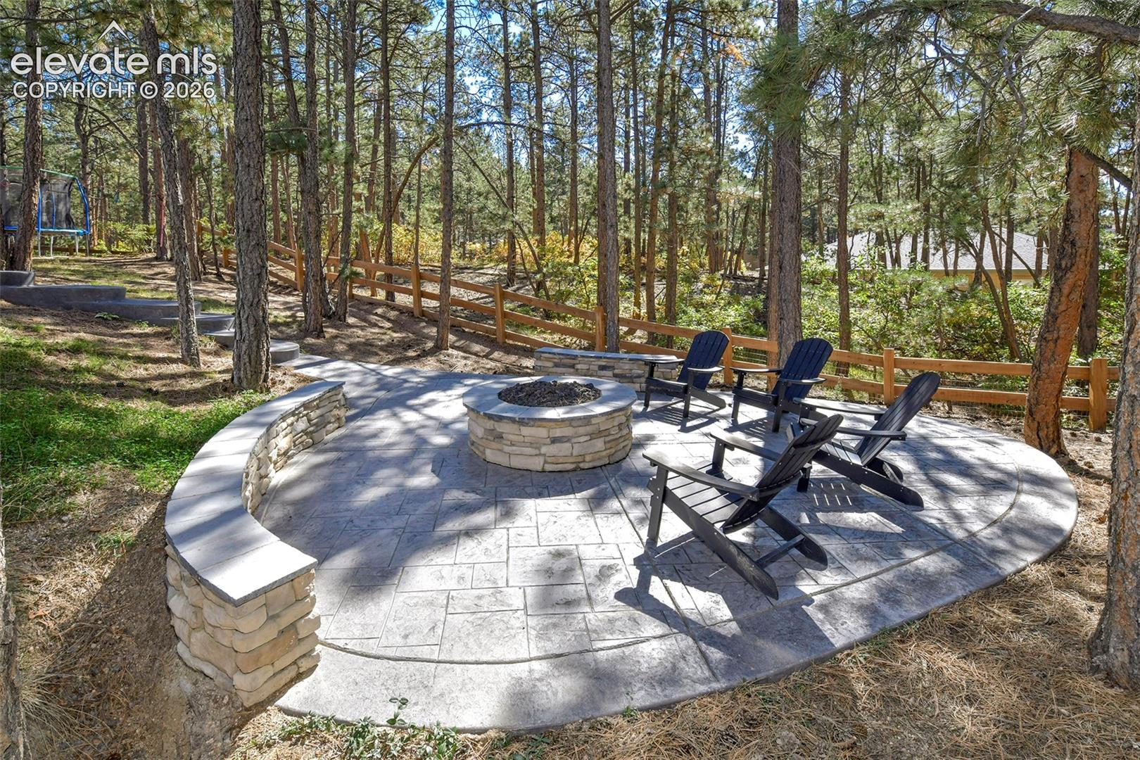 Stamped concrete with bench seating and natural gas fed firepit
