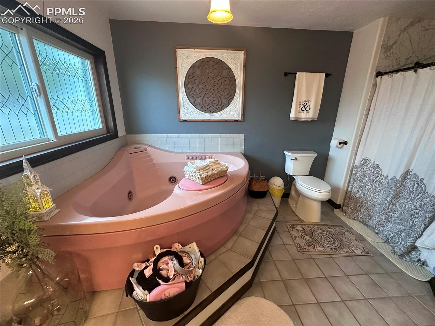 Jetted tub, toilet and shower on the right.