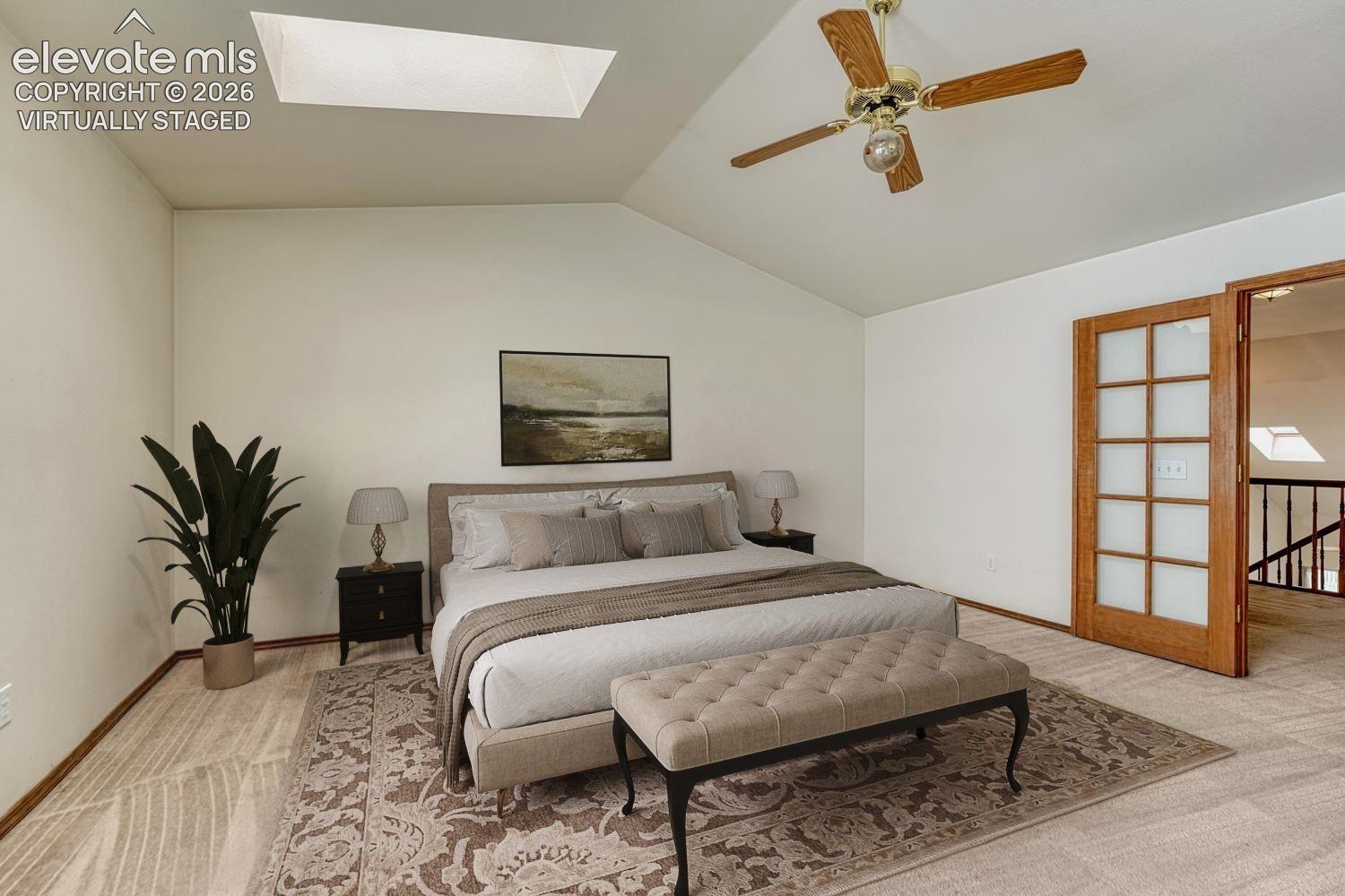 Owner's suite features vaulted ceiling with skylights, French doors, walk-in closet, and attached full bathroom. Virtually staged.