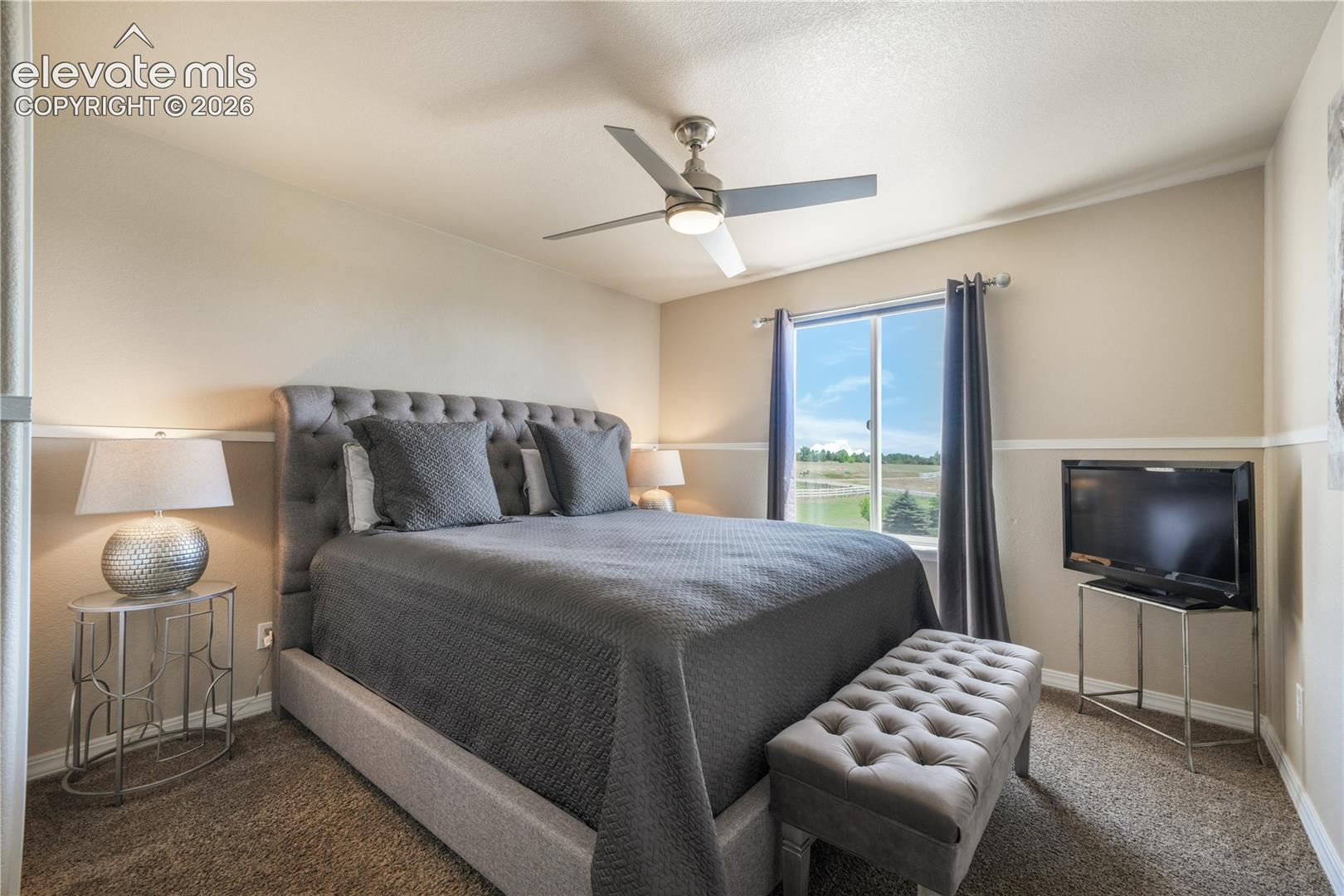 Upper Level Bedroom with Ceiling Fan and Walk-in Closet 