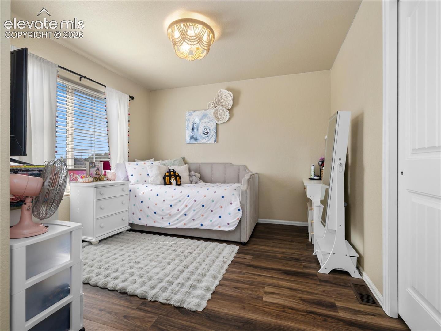 LVP flooring, neutral wall tones, and an ornate flush-mount ceiling light