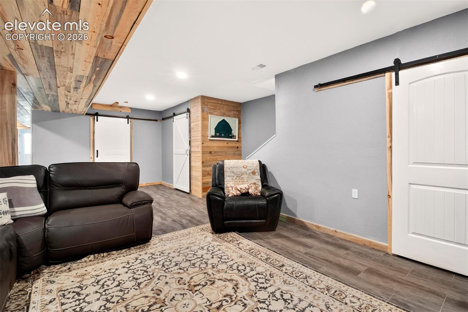 The custom pine accents elevate the entire lower level, creating a warm, sophisticated atmosphere perfect for a media room, home gym, or guest quarters!