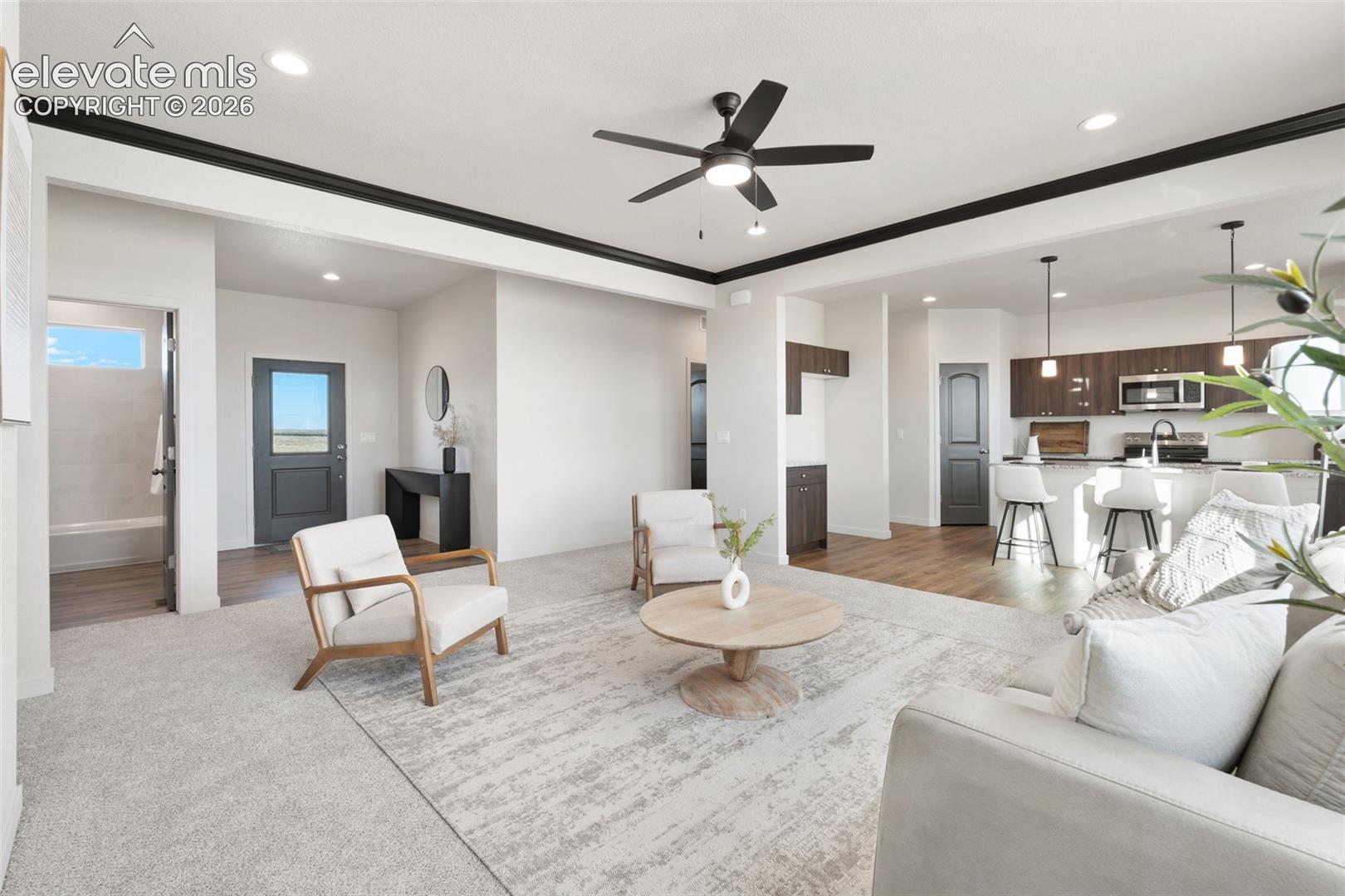 Open-concept living area with recessed lighting, a ceiling fan, and dark trim accents