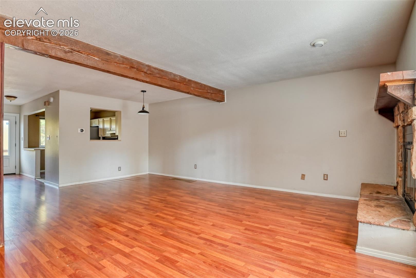 Wood-finish flooring with an exposed wood beam