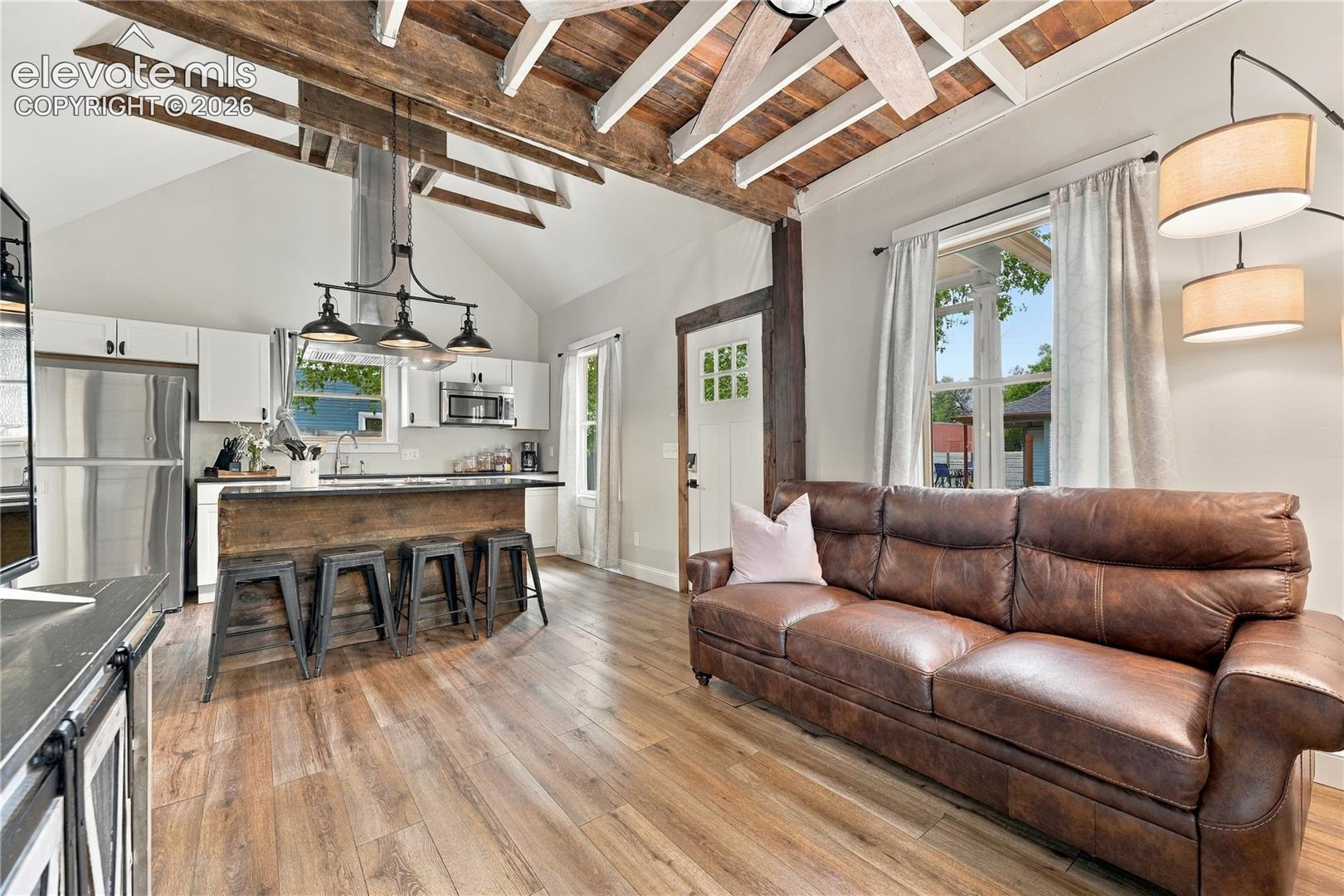 Opposite view from the entry into the living room with bonus loft area above.