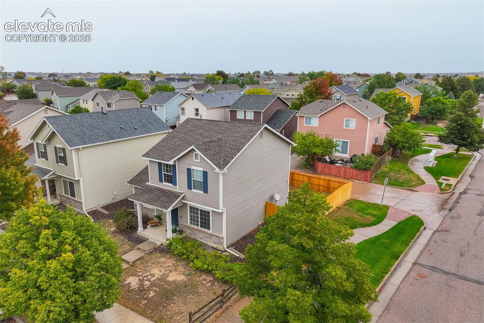 Two-story residence with siding exterior, covered entry, and attached garage