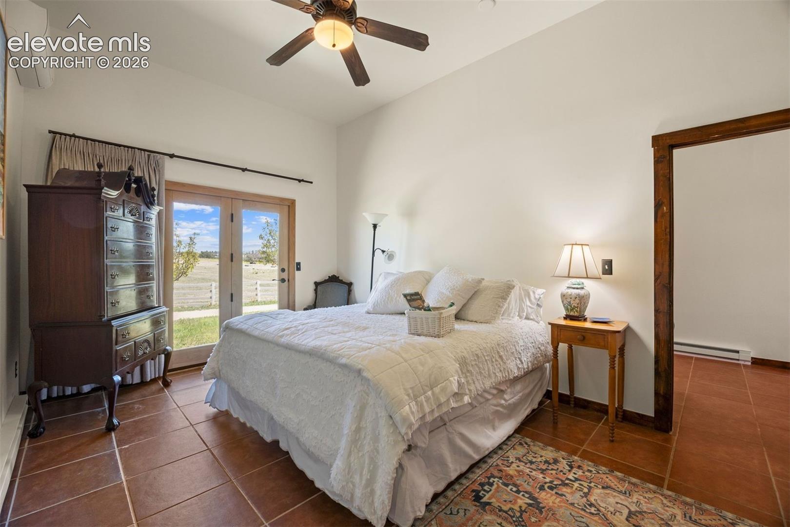 Spacious bedroom in the casita, with two closets, mini-split AC, and glass door walkout to a private patio, plus a bathroom and private laundry. 