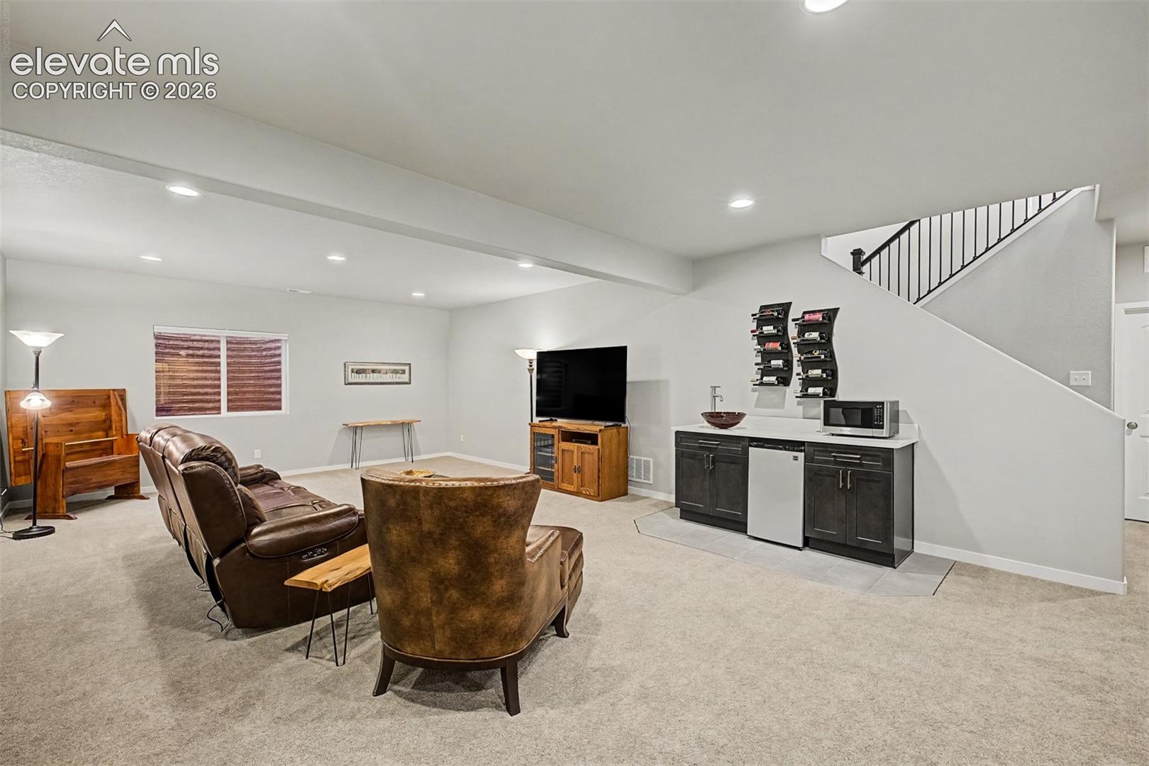 Spacious basement family room offers a comfortable second living area with plenty of room to relax, gather, and unwind.