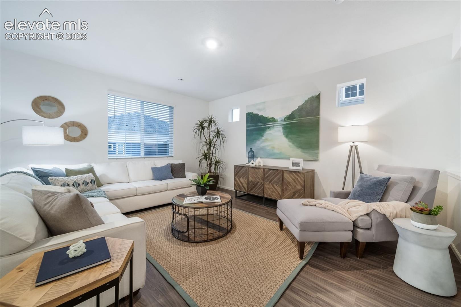 Wood-finish flooring, recessed lighting, and a large window with blinds
*photos of a model home*