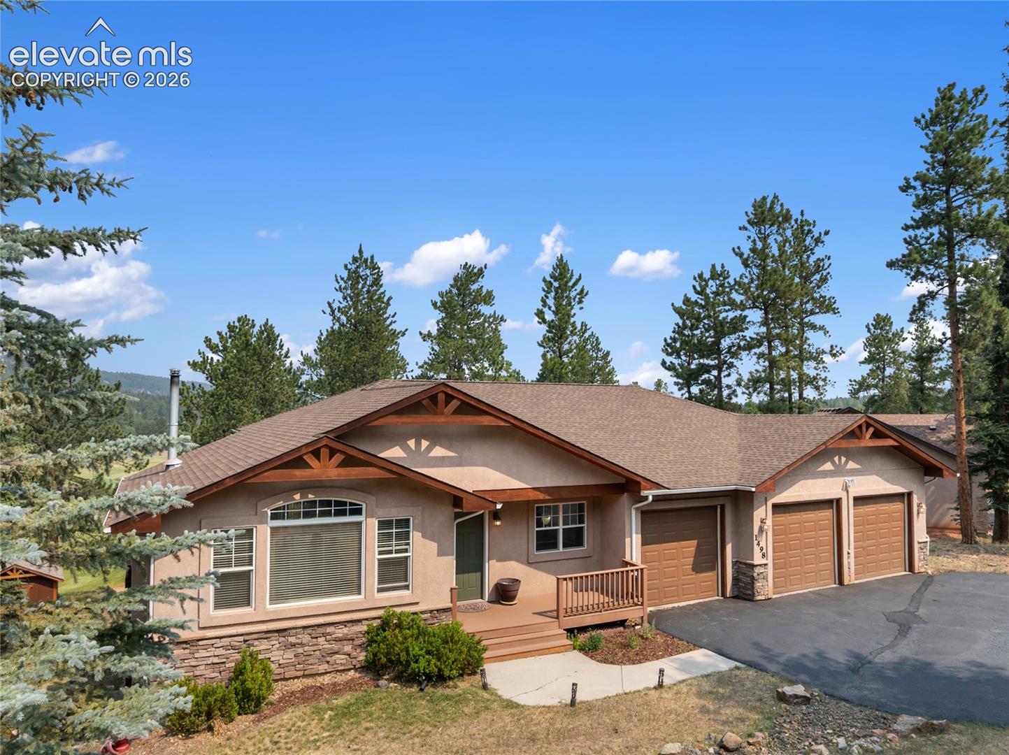 Welcome to your mountain retreat, where breathtaking natural beauty meets the timeless appeal of golf course living. Perfectly positioned along the 3rd green of Shining Mountain Golf Course, this exceptional home offers tranquility, recreation, and refined comfort surrounded by majestic mountain scenery. Whether you're seeking a full-time residence, vacation getaway, or the perfect place to entertain, this home delivers an extraordinary mountain lifestyle.Step inside this bright, airy main-level living home featuring hardwood floors, vaulted ceilings, and a spacious living room with a cozy fireplace framed by custom built-in cabinetry. Expansive windows fill the home with natural light and showcase the surrounding landscape.The modern kitchen boasts rare soapstone countertops, a large center island, and abundant workspace for everyday meals or holiday gatherings. The dining area flows seamlessly into the kitchen and living room and opens to the deck, where you'll enjoy the scent of pine trees, fresh cut grass, and views of the golf course.The spacious primary suite features an updated five-piece ensuite with a soaking tub and a generous walk-in closet. A guest bedroom and full bath complete the main level.The walk-out lower level offers a large family room with space for a pool table, games, and entertaining. A wood-burning stove provides warmth and helps heat both levels of the home. Three additional guest bedrooms and a bath offer plenty of room for family and visitors. During the winter off-season, the course transforms into a network of picturesque walking trails.Outdoor recreation is just minutes away, including Florissant Fossil Beds National Monument, Dome Rock State Park, Mueller State Park, and National Forest access. Fishing at 11 Mile Reservoir, Spinney Mountain Reservoir, and the renowned Dream Stream is within 30 minutes, while Breckenridge skiing is less than two hours away.