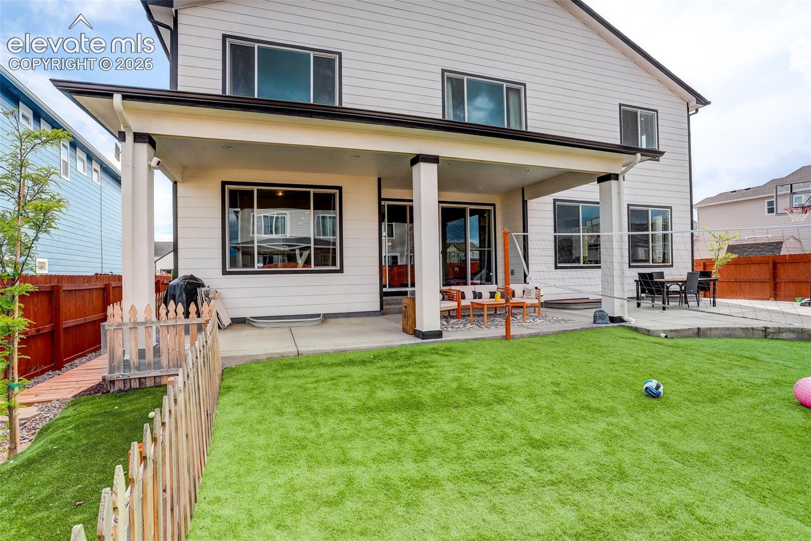 Rear view of house featuring a fenced backyard and a covered patio