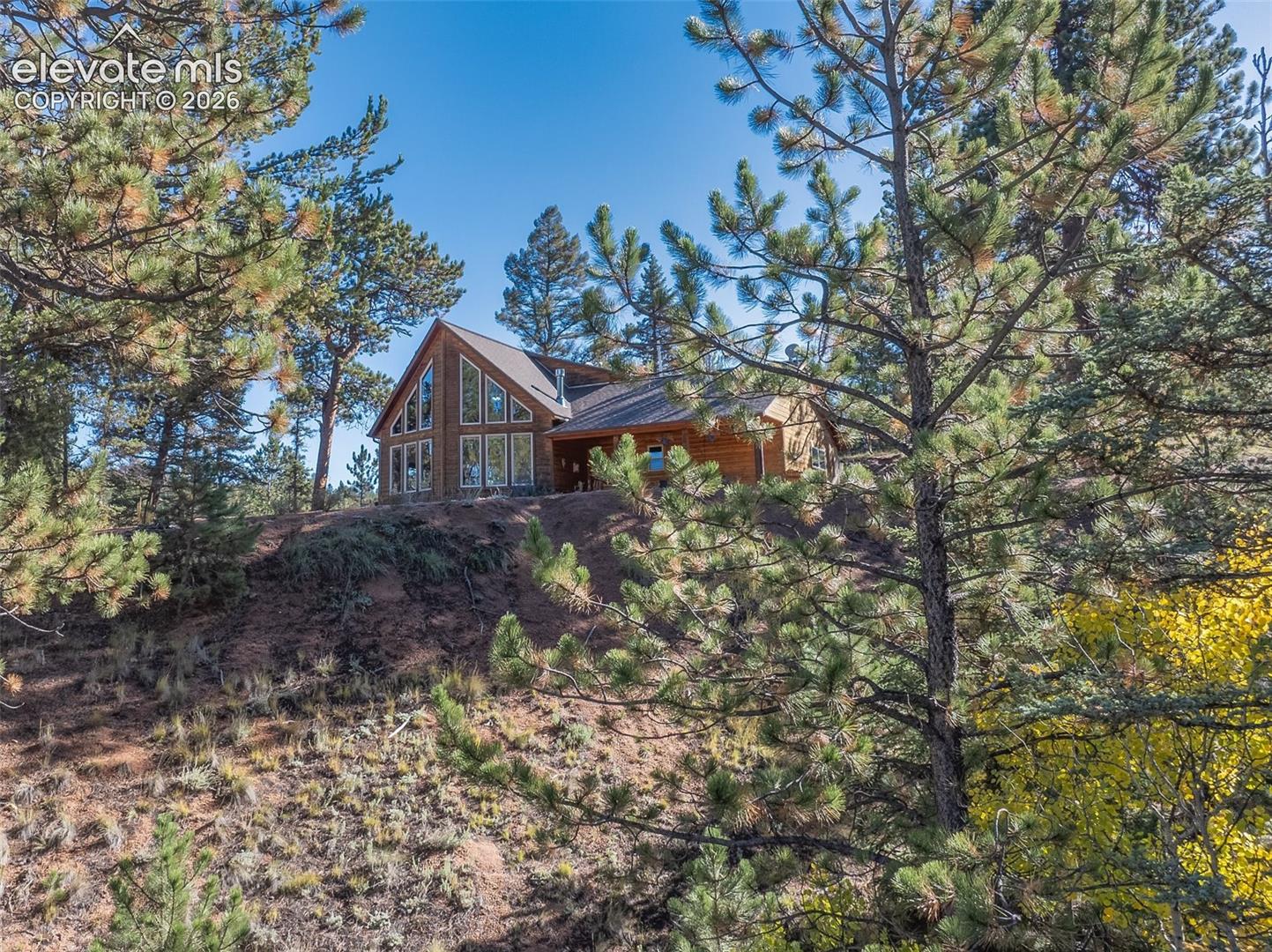 Wood-sided home featuring a prominent A-frame architectural style