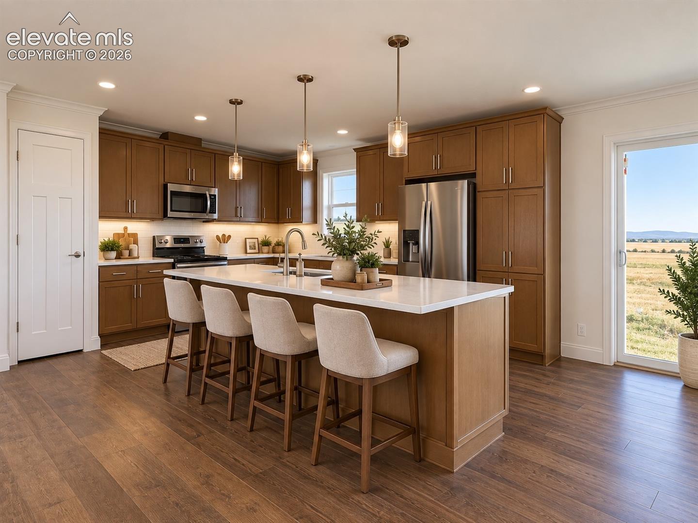 Kitchen – Well-appointed kitchen centers around a substantial island with seating, pendant lighting, plentiful cabinetry, stainless steel appliances, and generous preparation space.